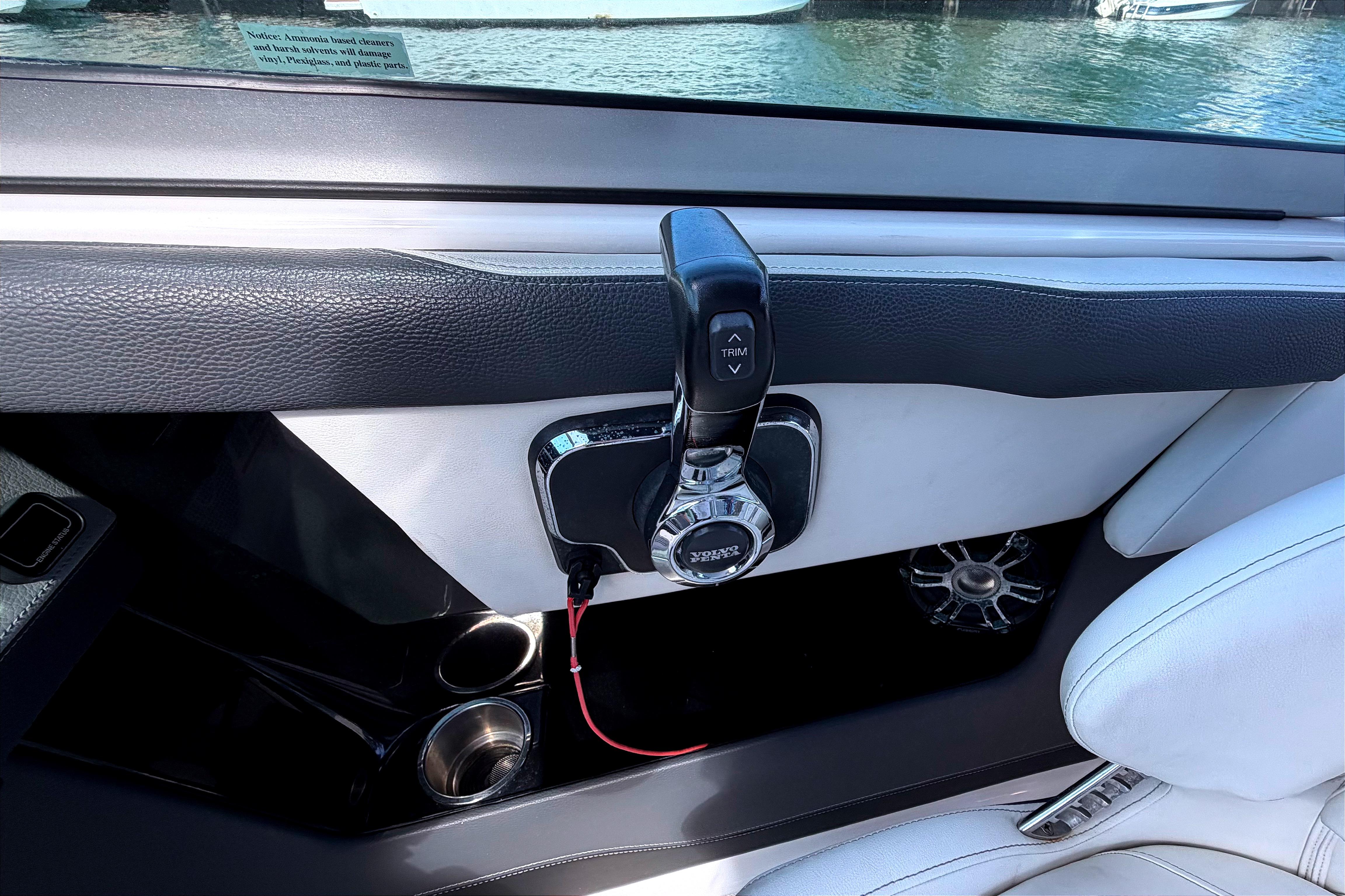 Interior of 2020 Regal 2300 Bowrider boat with throttle control and cup holders.