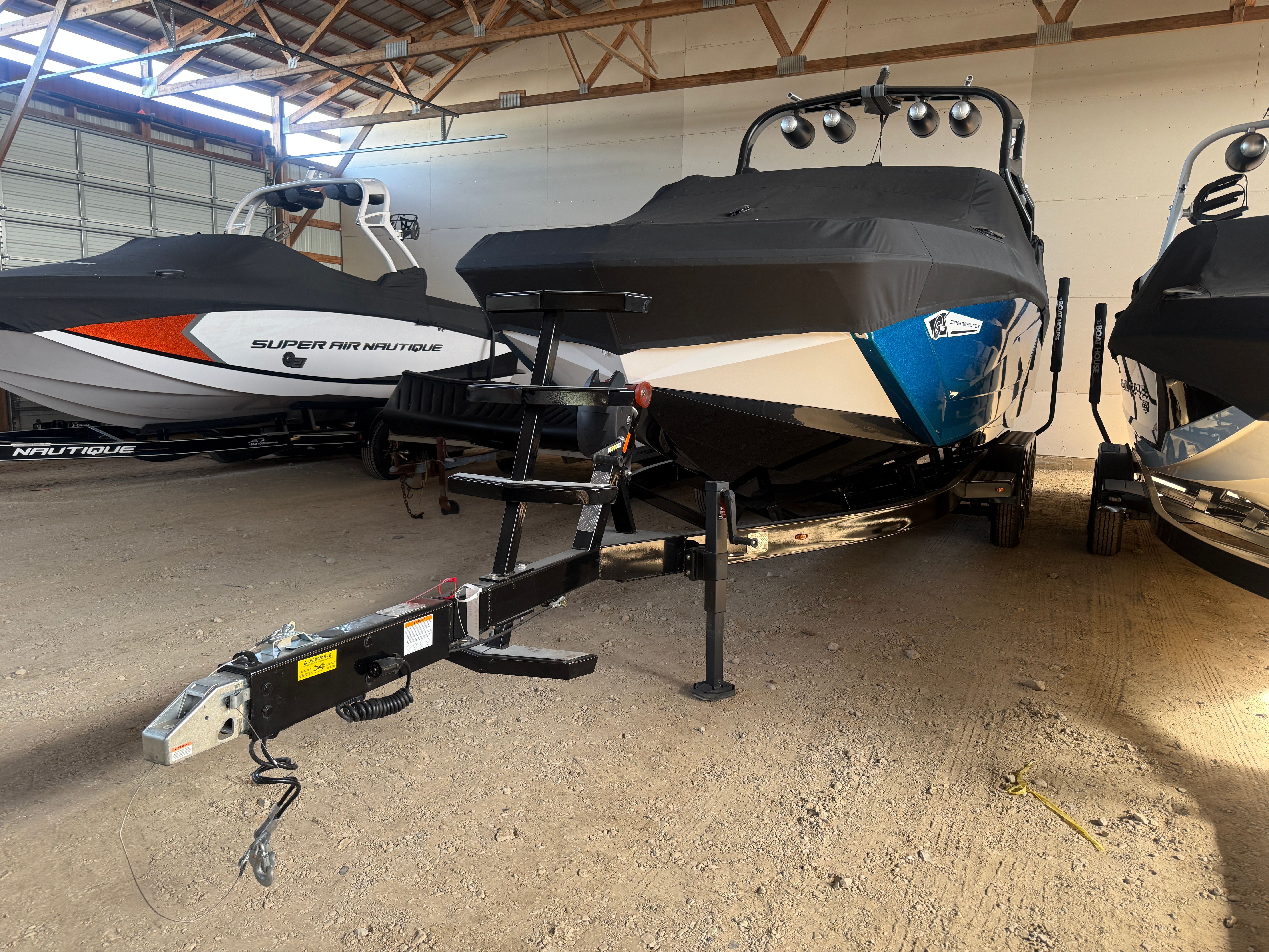 2021 Nautique Super Air Nautique G25 in warehouse on trailer.