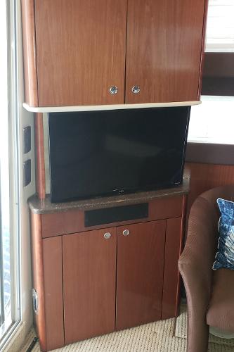 2010 Meridian 441 Sedan interior with TV and wooden cabinetry.