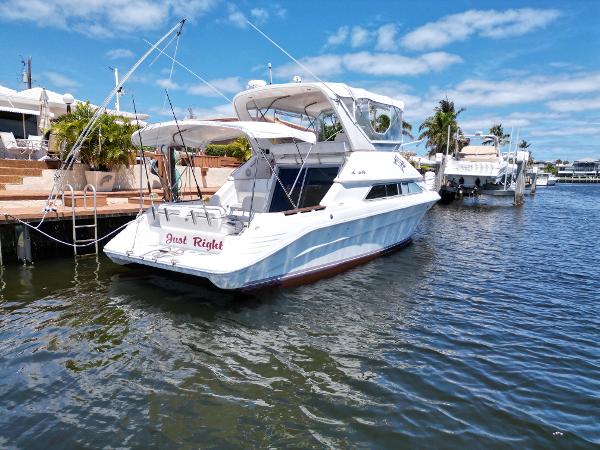 1992 Sea Ray 350 Express Bridge docked in a marina on a sunny day.