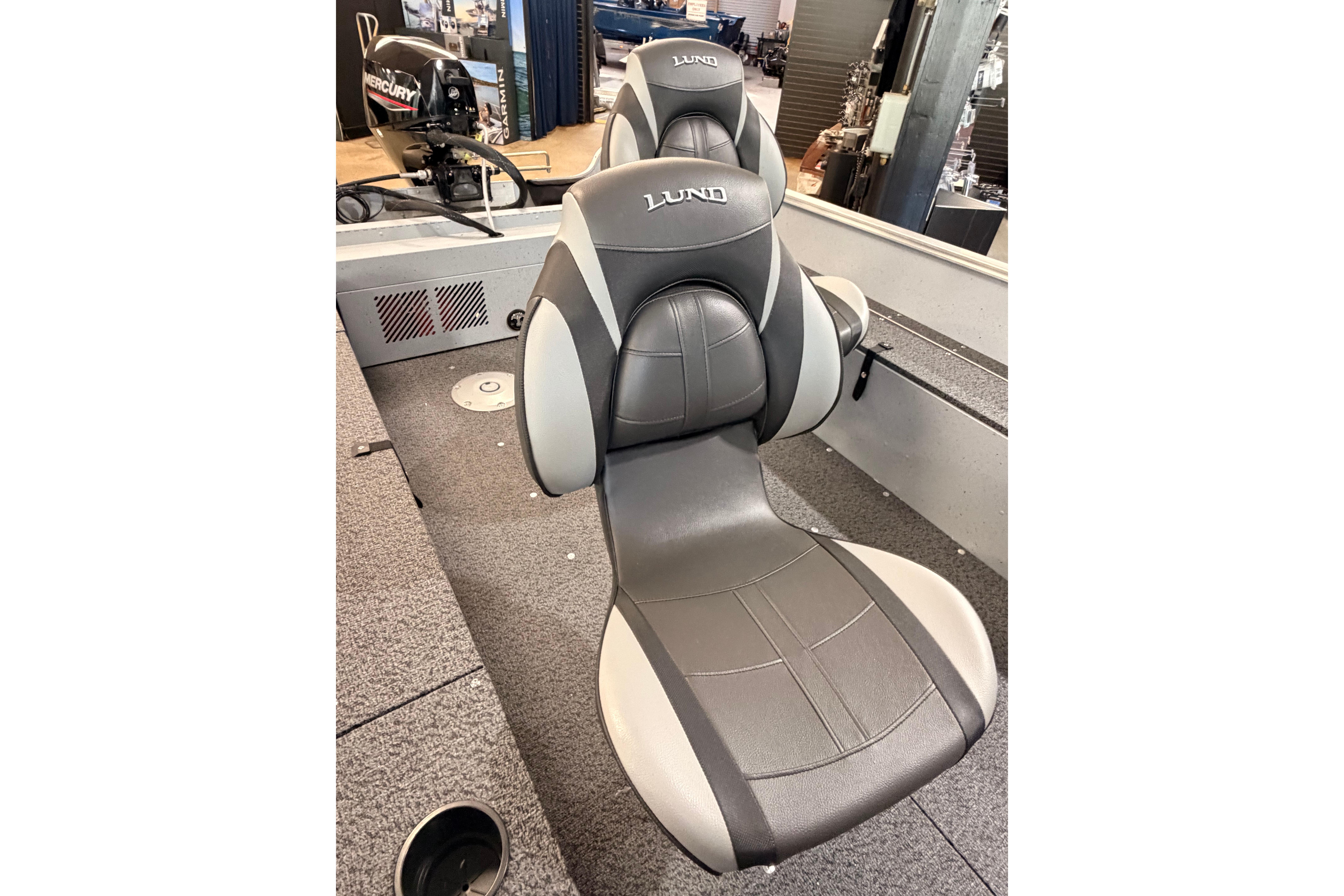 2027 Lund 1600 Fury SS boat interior with comfortable seating and Mercury engine in background.