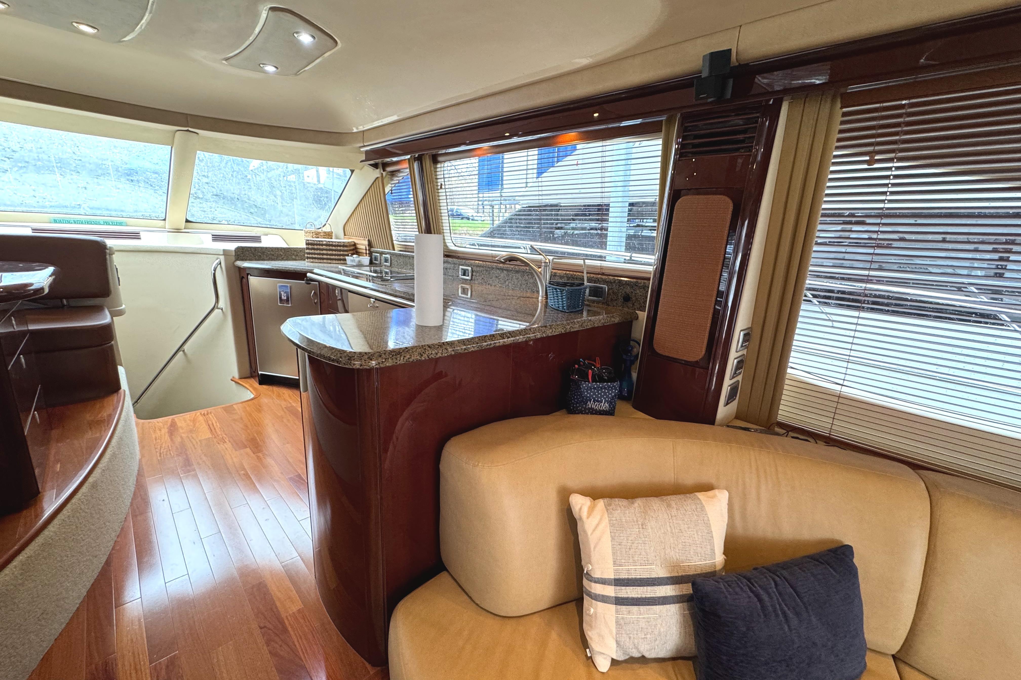 Luxurious interior of 2007 Sea Ray 58 Sedan Bridge yacht with modern kitchen and seating area.