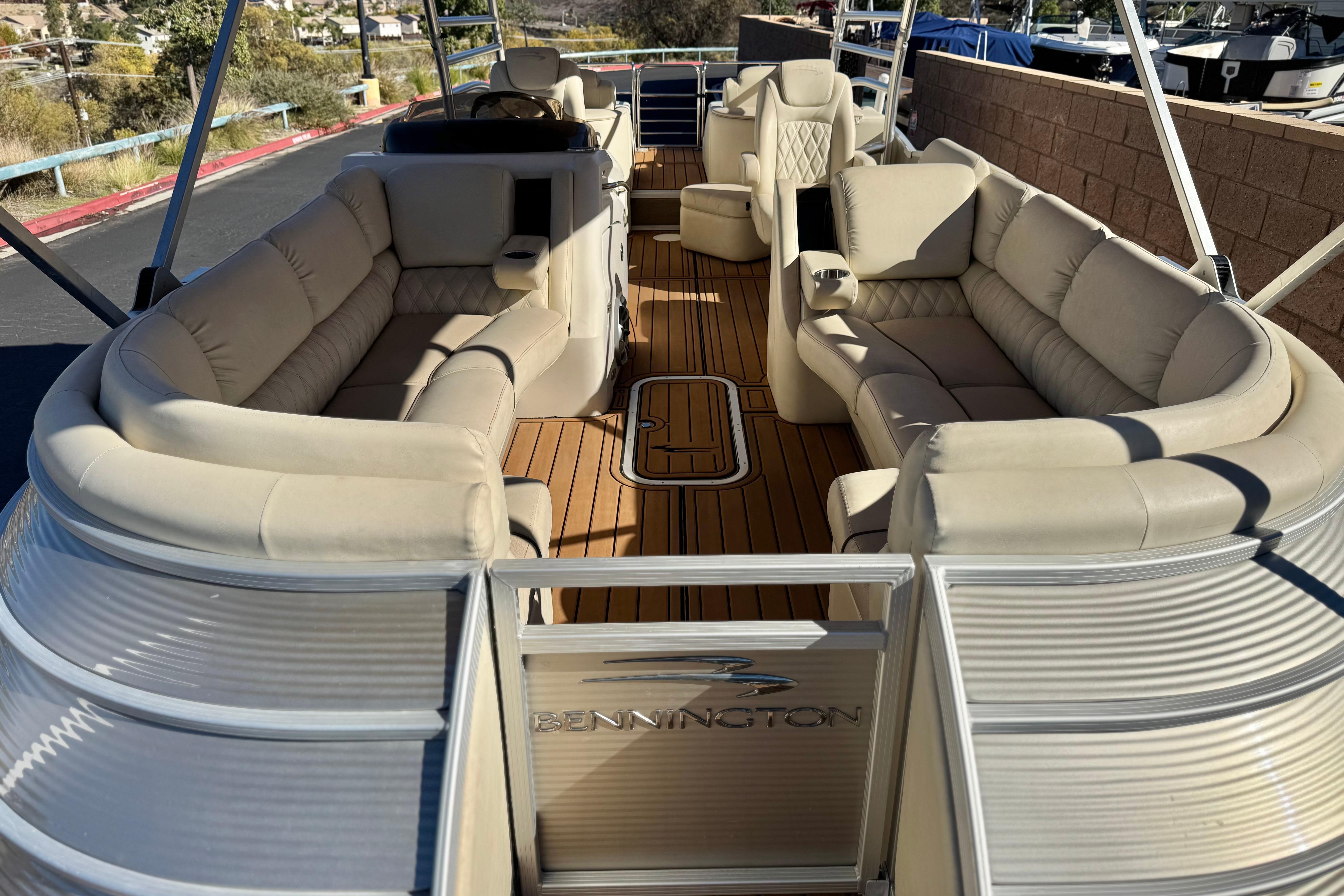 2013 Bennington 2575QCW I/O pontoon boat with luxurious seating and spacious deck.