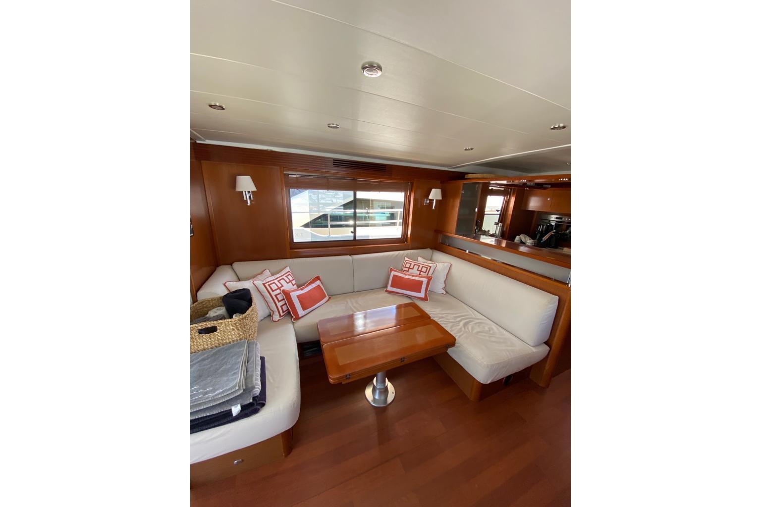 Luxurious interior of 2012 Beneteau Swift Trawler 52 with elegant seating and wooden accents.