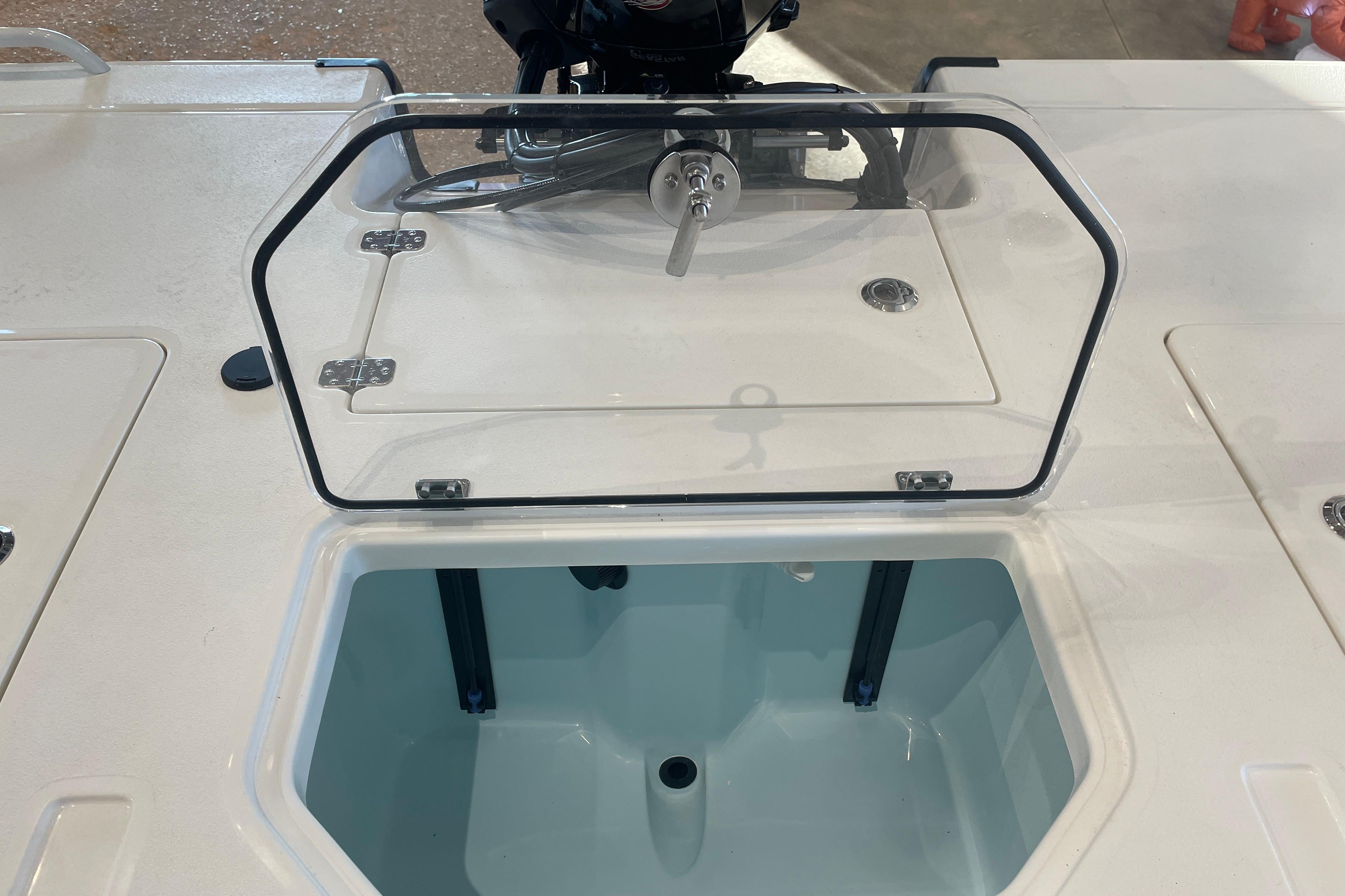 2026 Mako 18 Pro Skiff livewell with open lid, showcasing interior design.