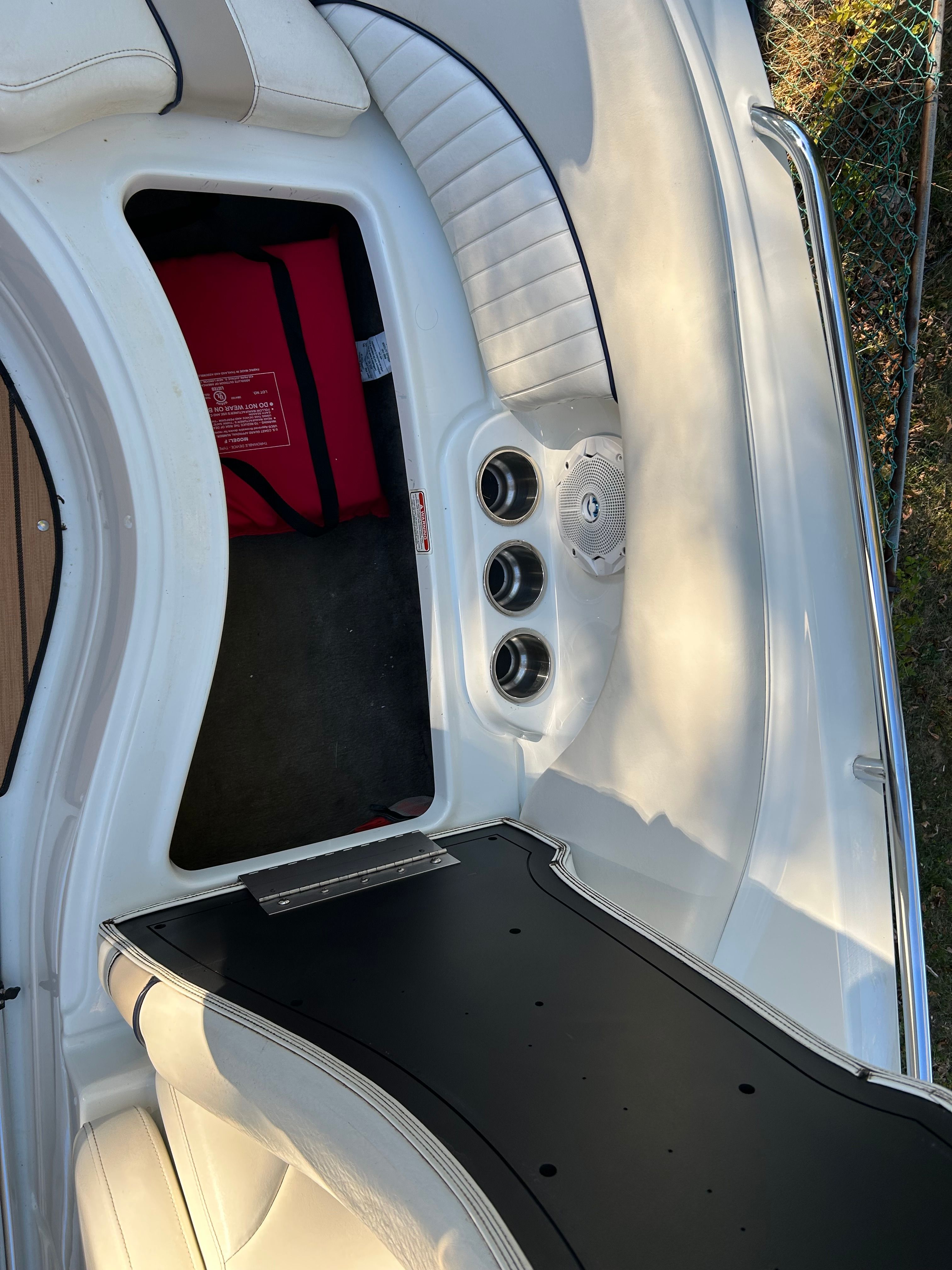The image shows the cockpit of a 2008 Azure AZ220 boat with white upholstery and cup holders.
