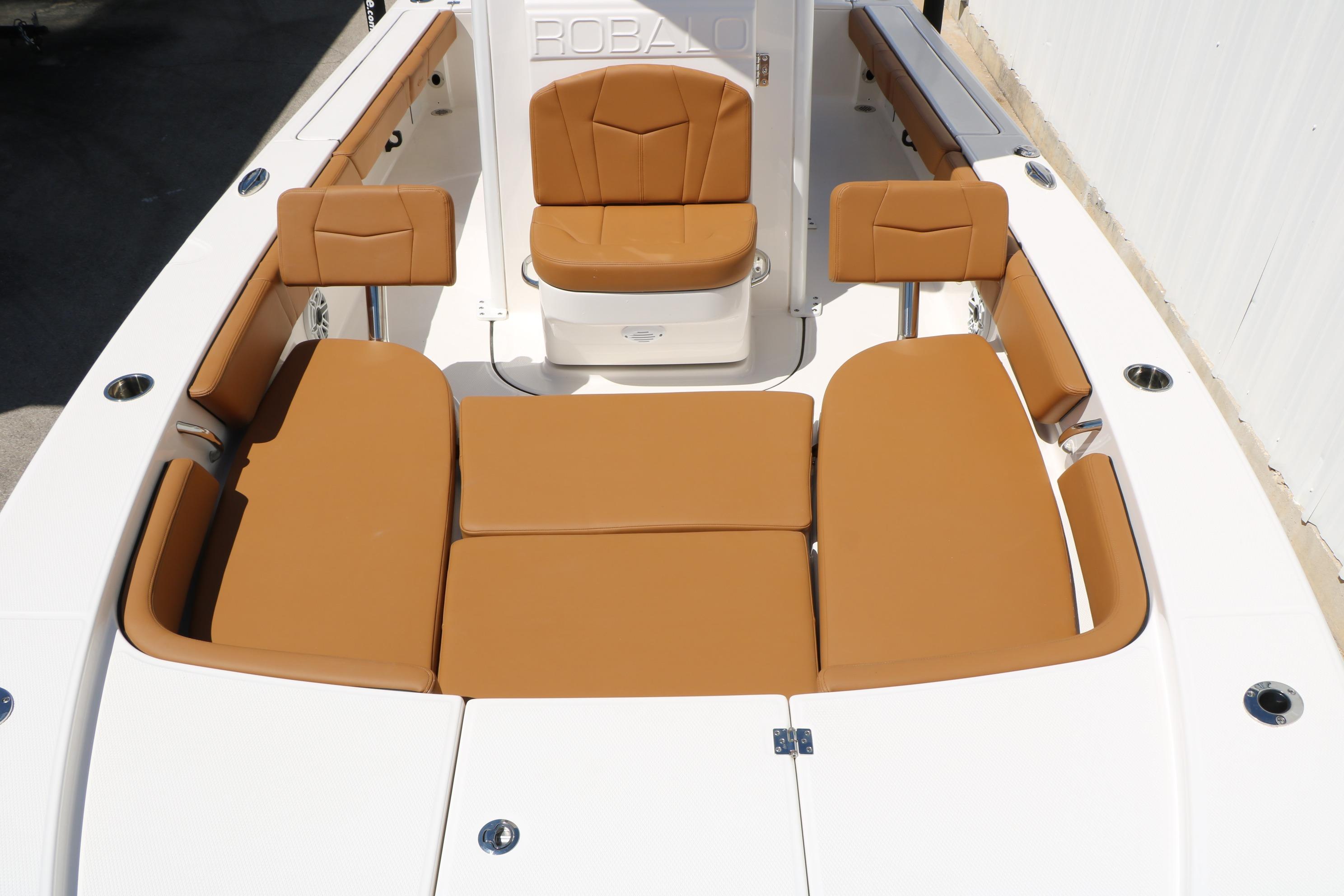 2026 Robalo 246 Cayman boat interior with tan cushioned seating.