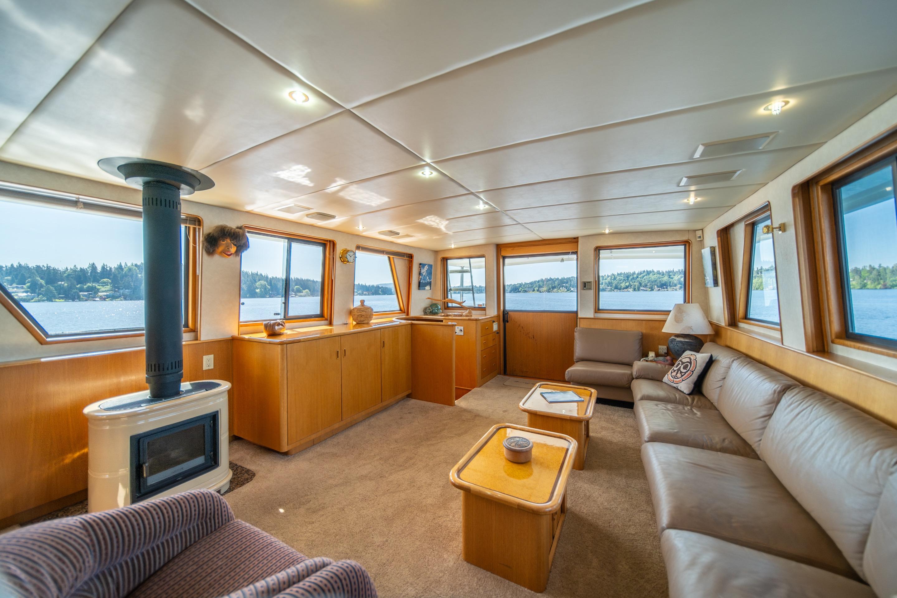 Luxurious interior of 1991 Forbes Cooper Pilothouse Motoryacht with panoramic windows and cozy seating.