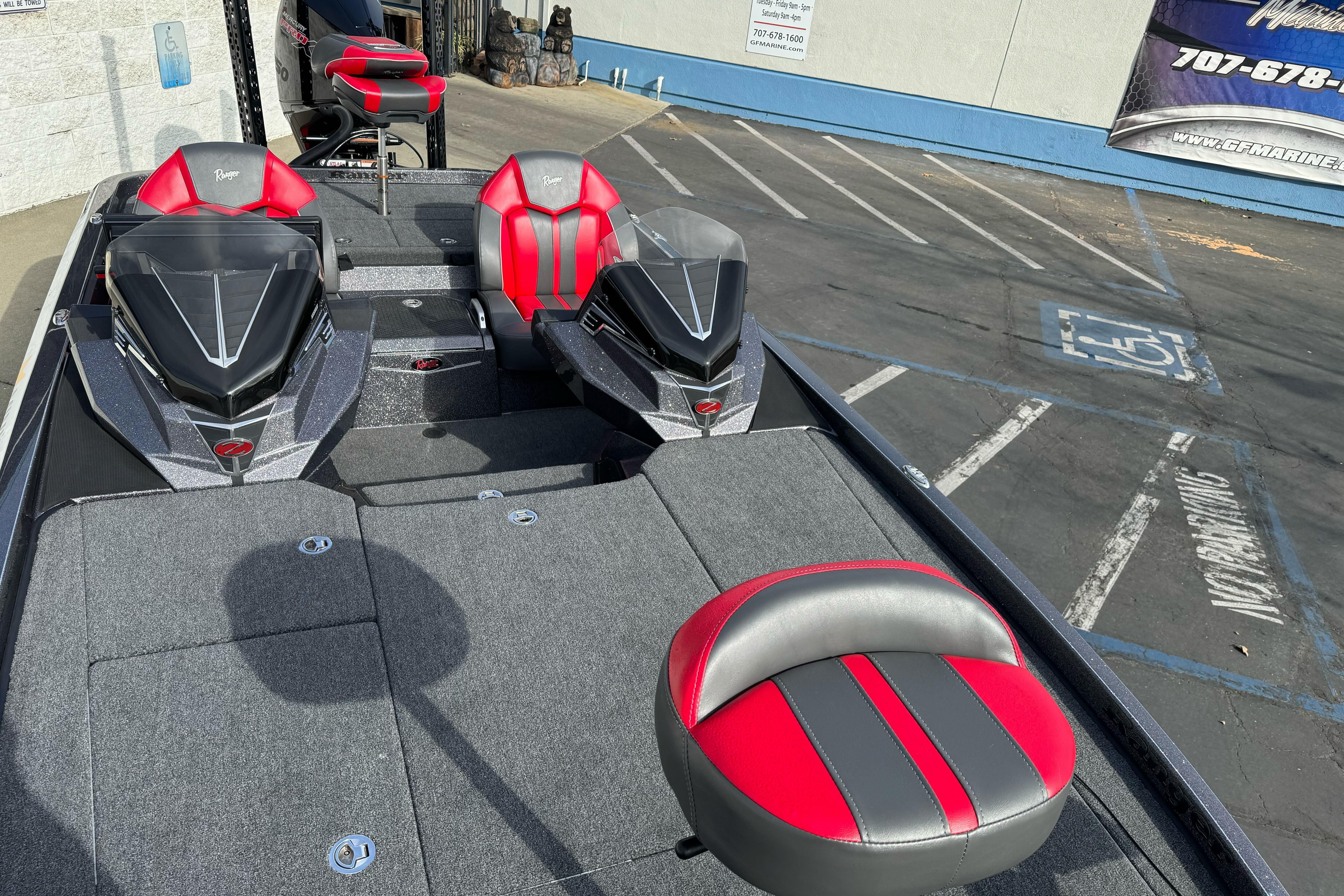 2025 Ranger Z521 boat with red and gray seating, parked in a lot.