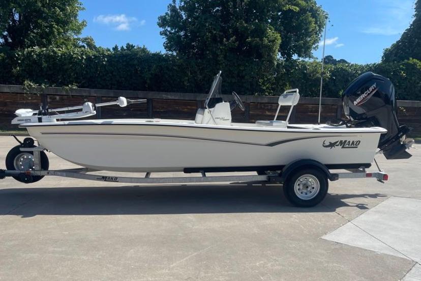 2026 Mako Pro Skiff 17 CC boat on trailer, parked outdoors.