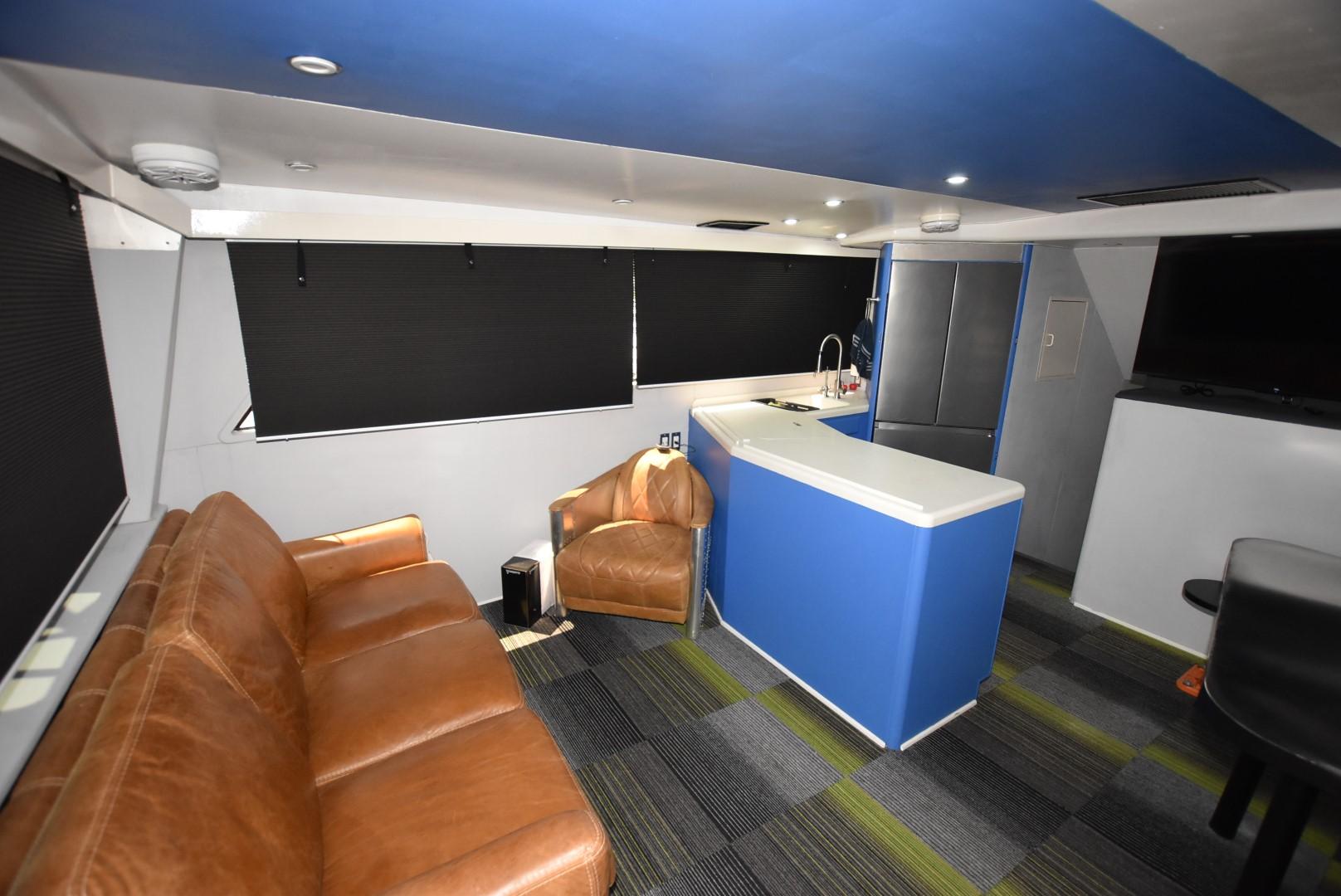 Interior of 1997 Viking 50 Convertible yacht with leather seating and modern kitchenette.