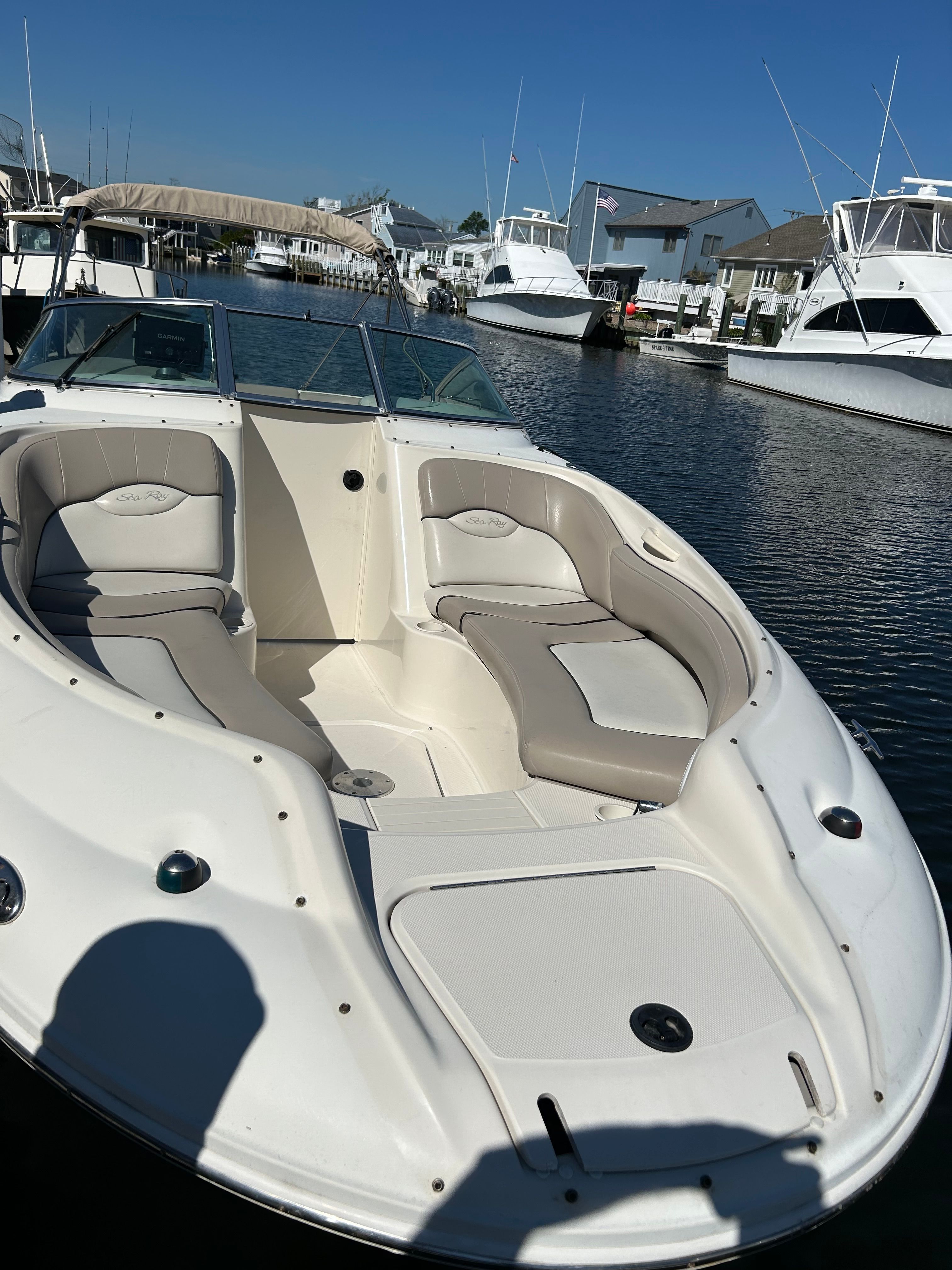 2003 Sea Ray 240 Sundeck boat docked, sunny day.