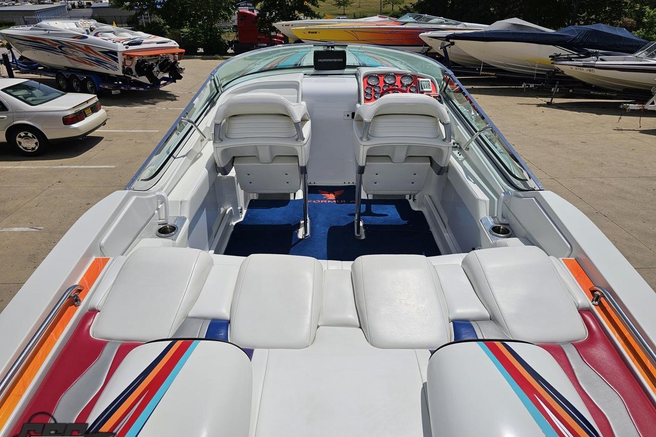 2002 Formula 382 FASTech boat interior with colorful upholstery and dual seating.