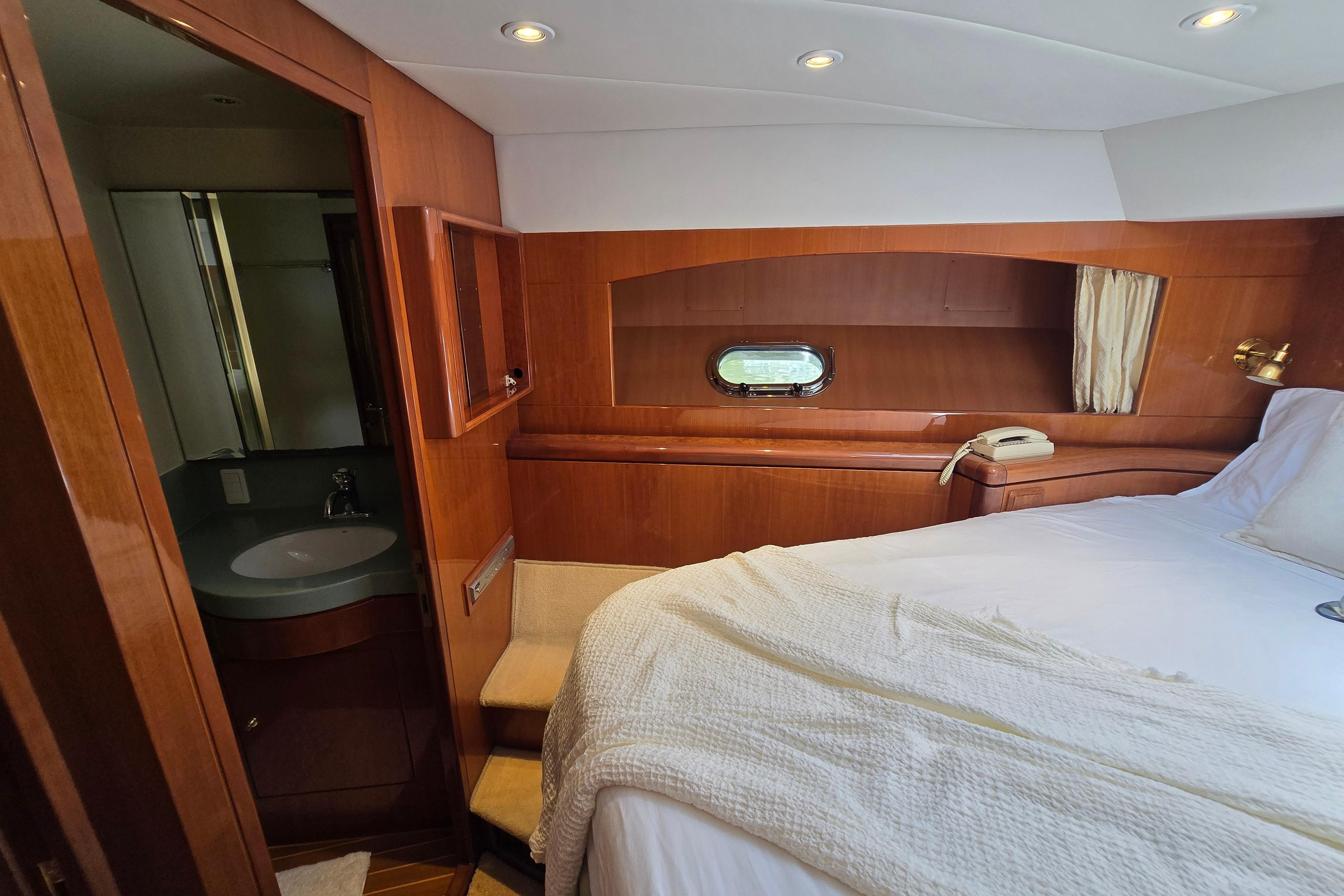 Luxurious 2004 Grand Harbour 58 yacht cabin with wood paneling and ensuite bathroom.