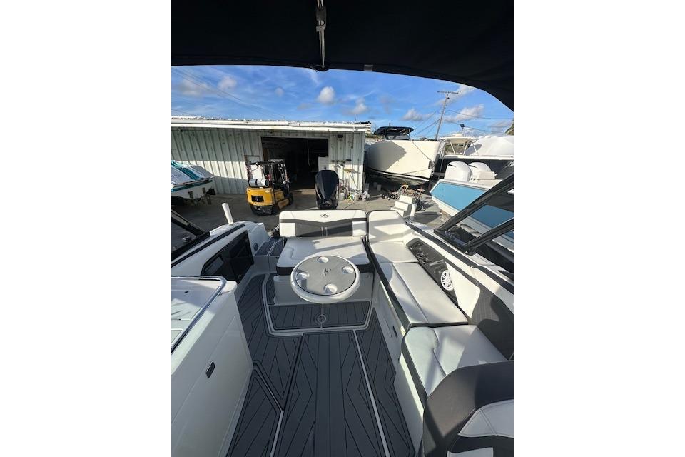 2022 Monterey 255SS Super Sport boat interior with seating and table, docked outdoors.