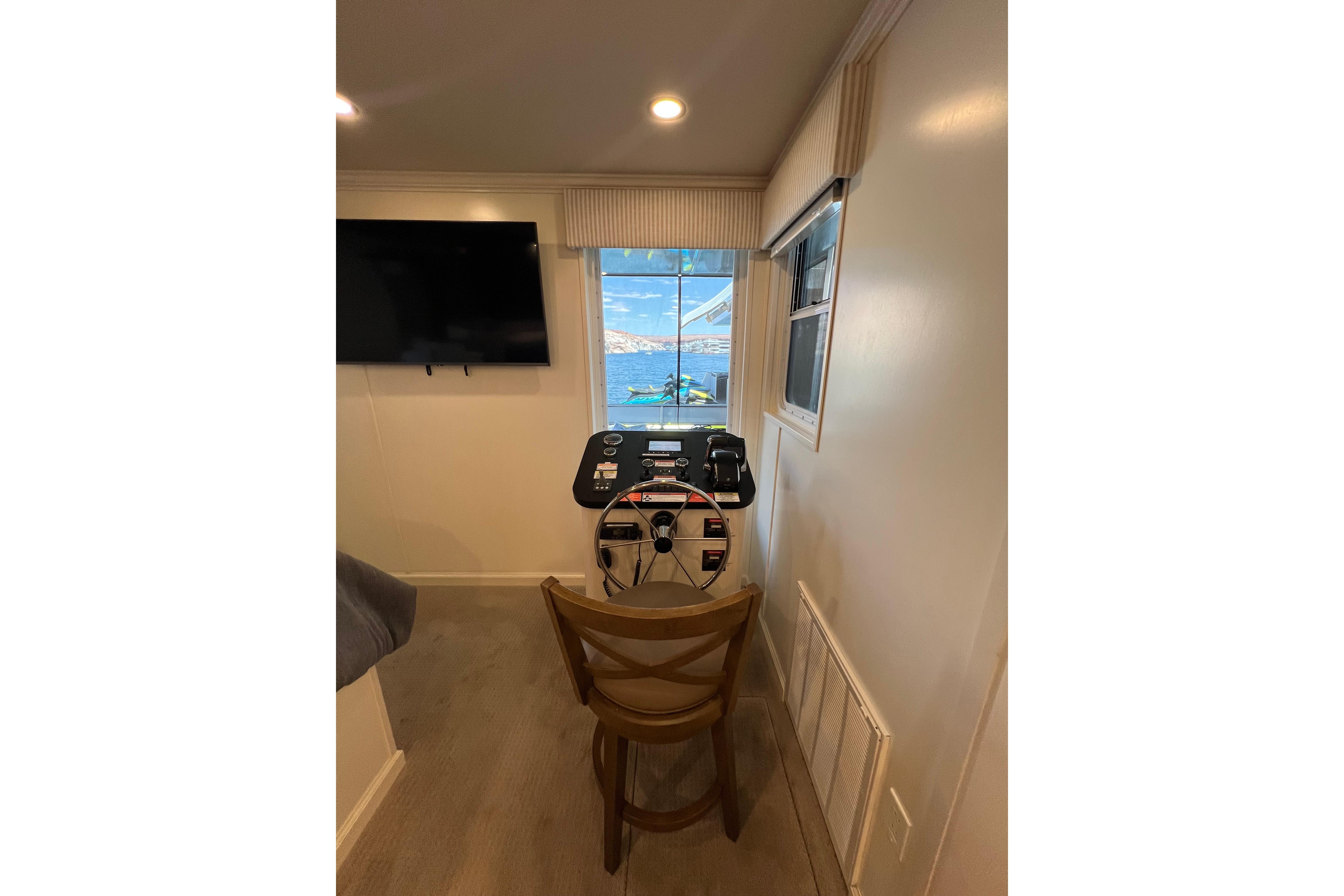 Interior of 2025 Sumerset Excellence Multiple Shares houseboat with steering wheel and window view.