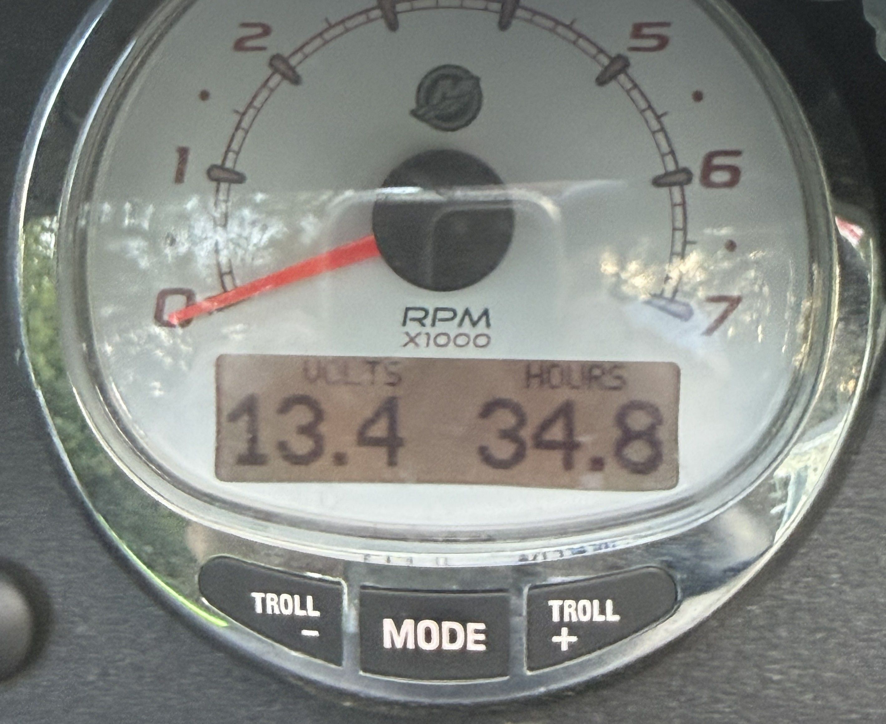 Close-up of a boat tachometer showing 13.4 volts and 34.8 hours.