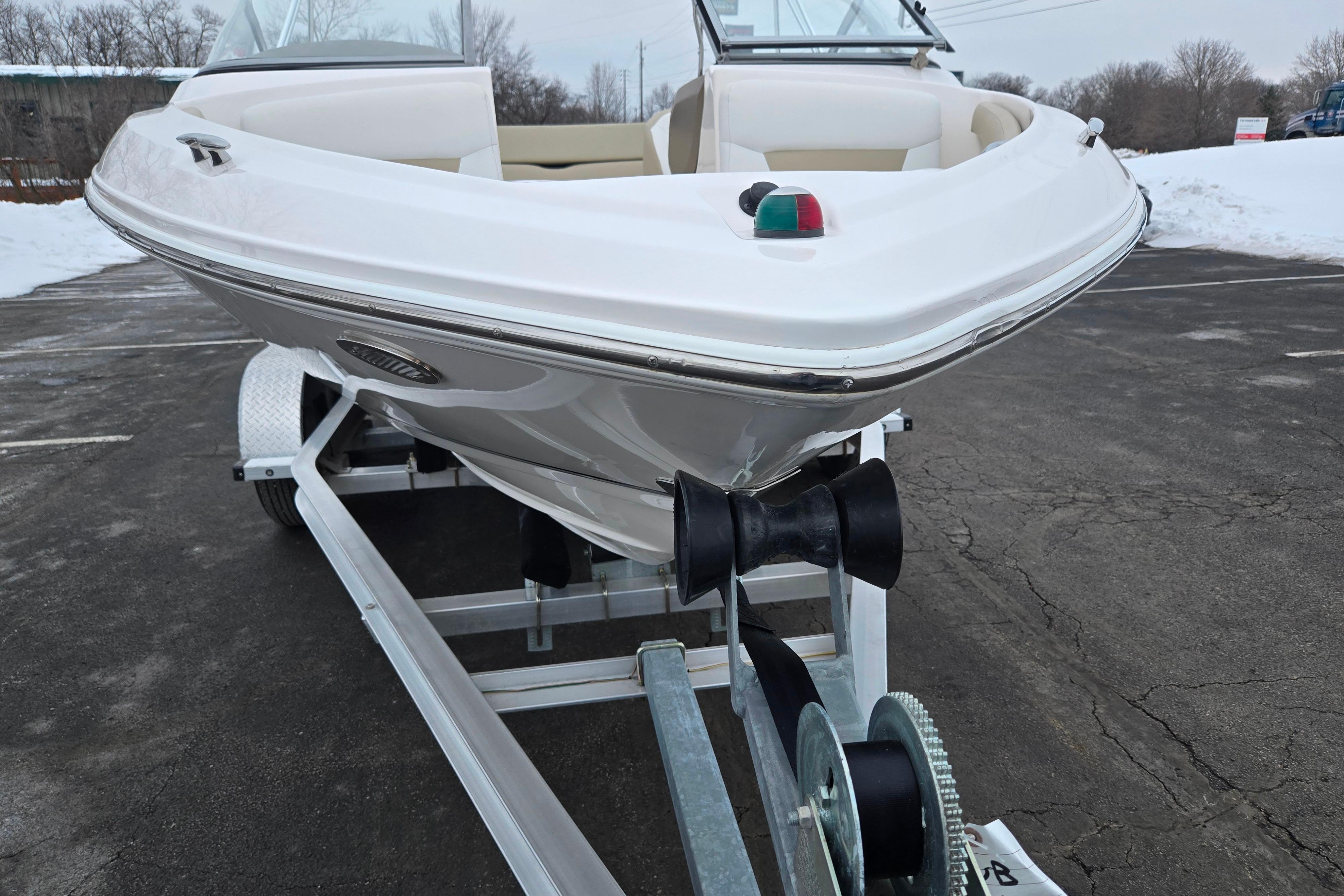2015 Regal 1900 ES Bowrider on trailer in snowy parking lot.