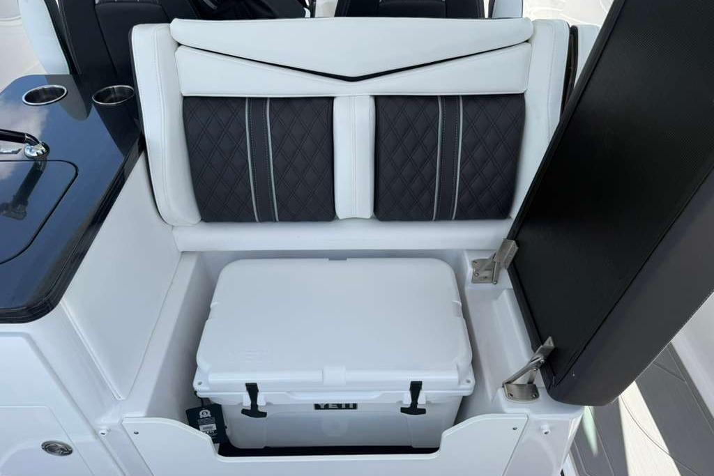 2026 Monterey Elite 30 OB boat interior with cushioned seating and built-in cooler storage.