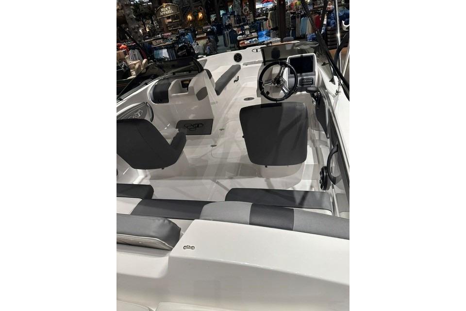 2026 Tahoe T21 boat interior with steering wheel and seating in showroom.