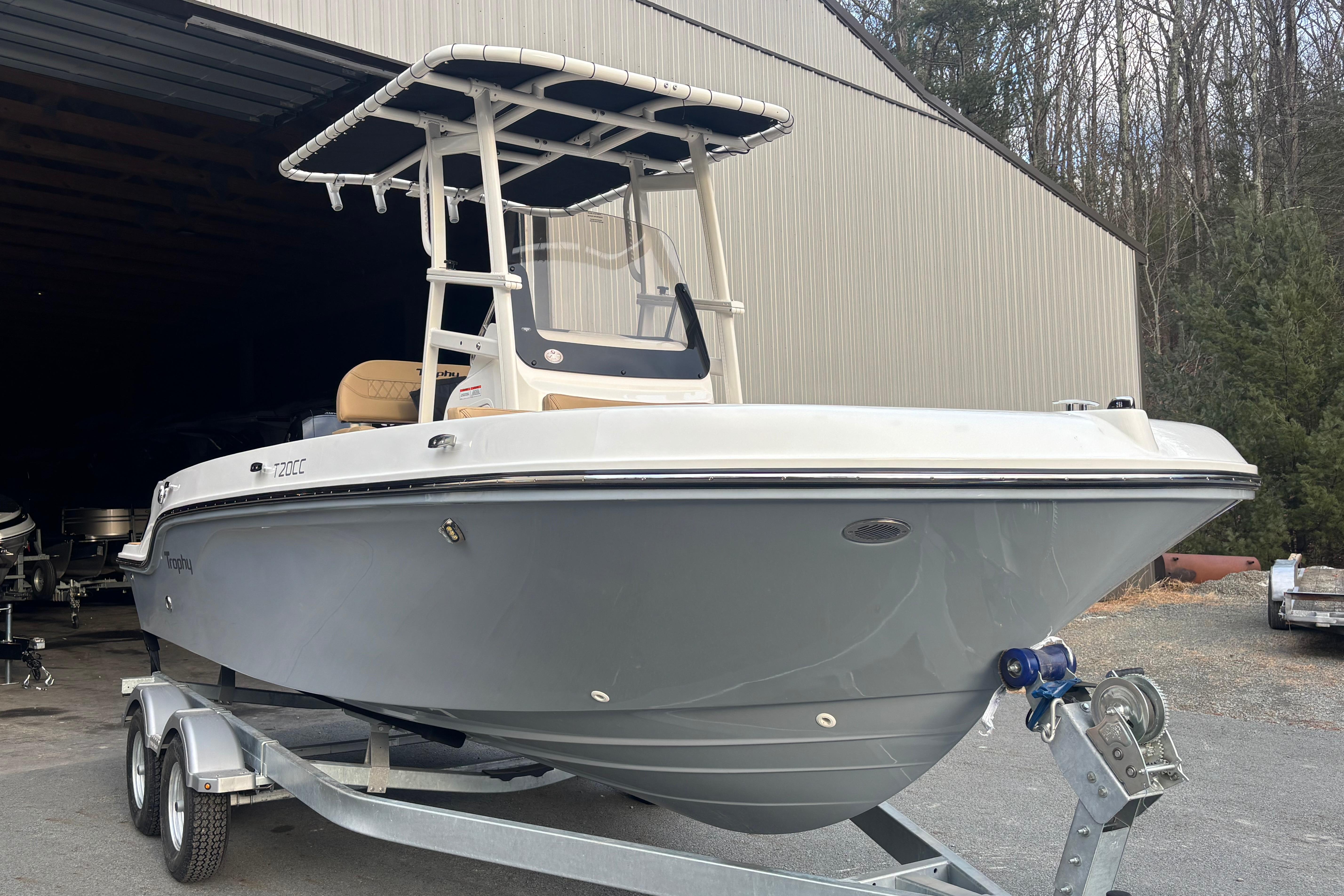 2026 Bayliner Trophy T20CC boat on trailer near a large shed.