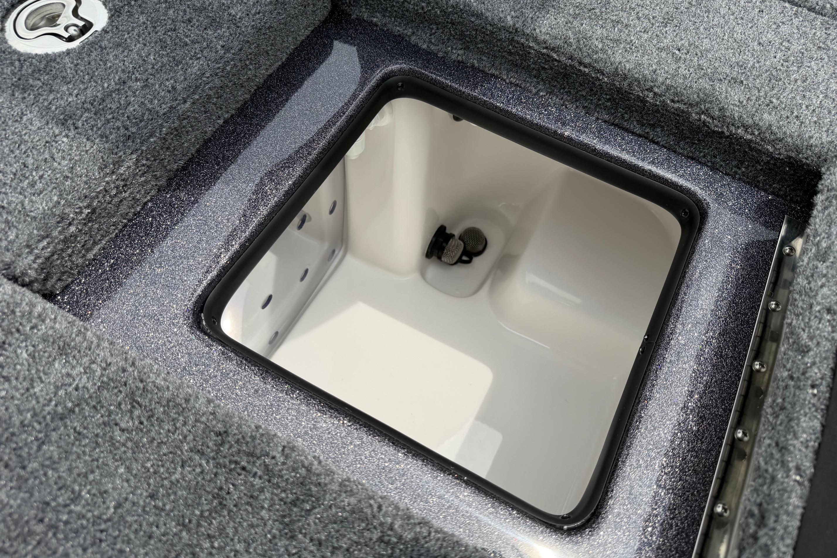 2027 Falcon Boats F215 livewell interior with gray carpeted edges.