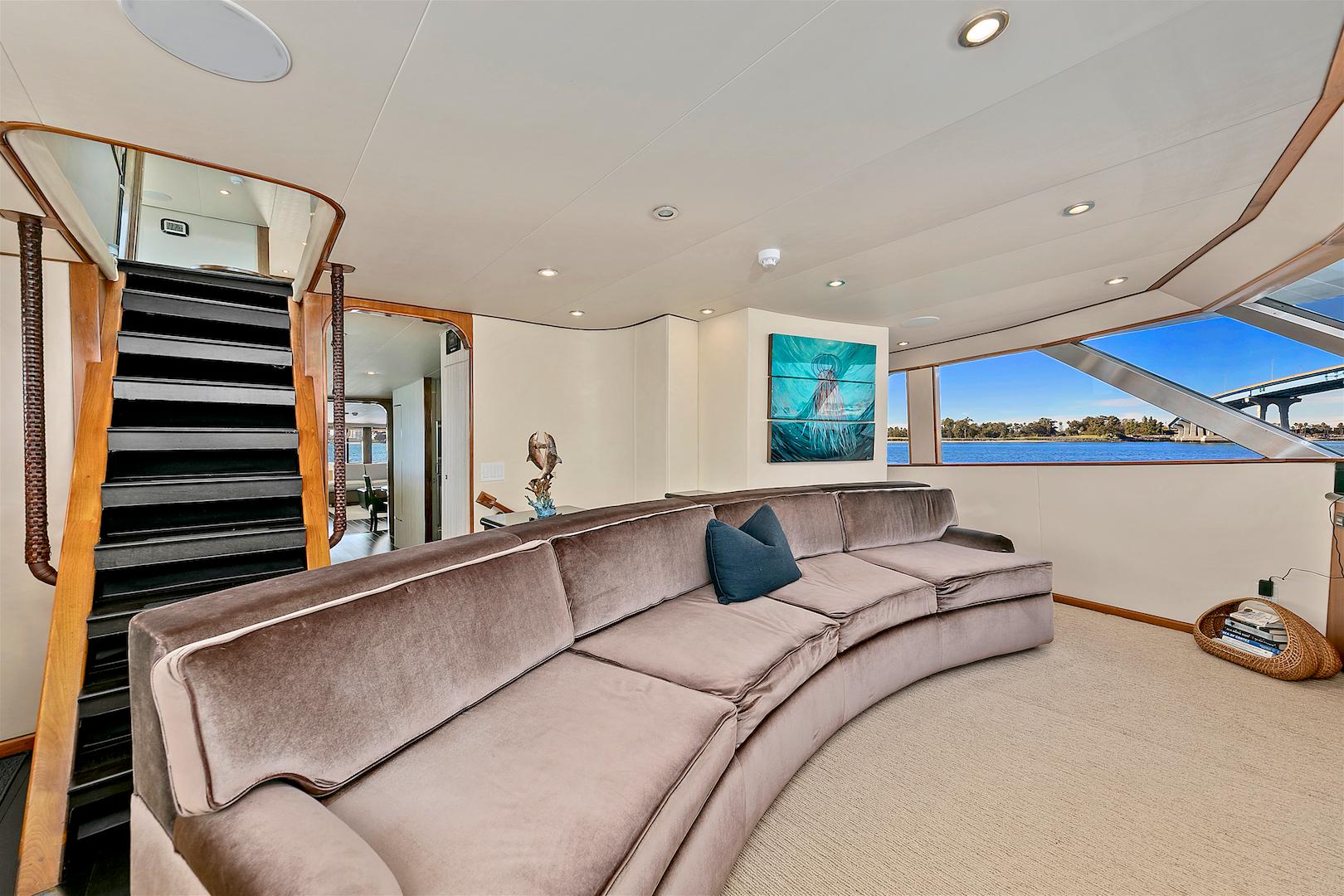Luxurious 1987 Deep Sea Marine motor yacht interior with plush seating and scenic window views.