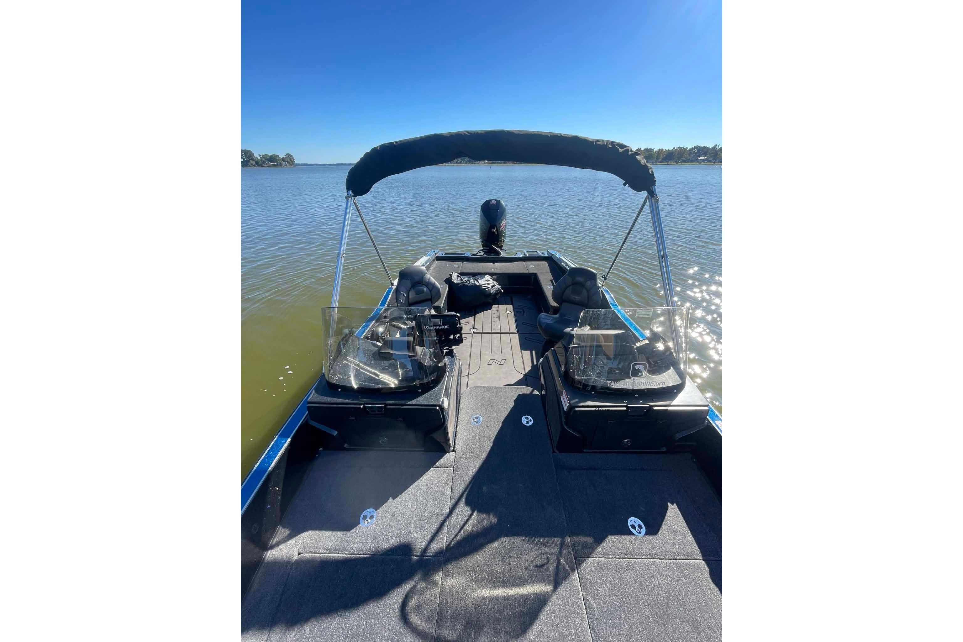 2024 Nitro ZV21 boat on calm lake under clear blue sky.