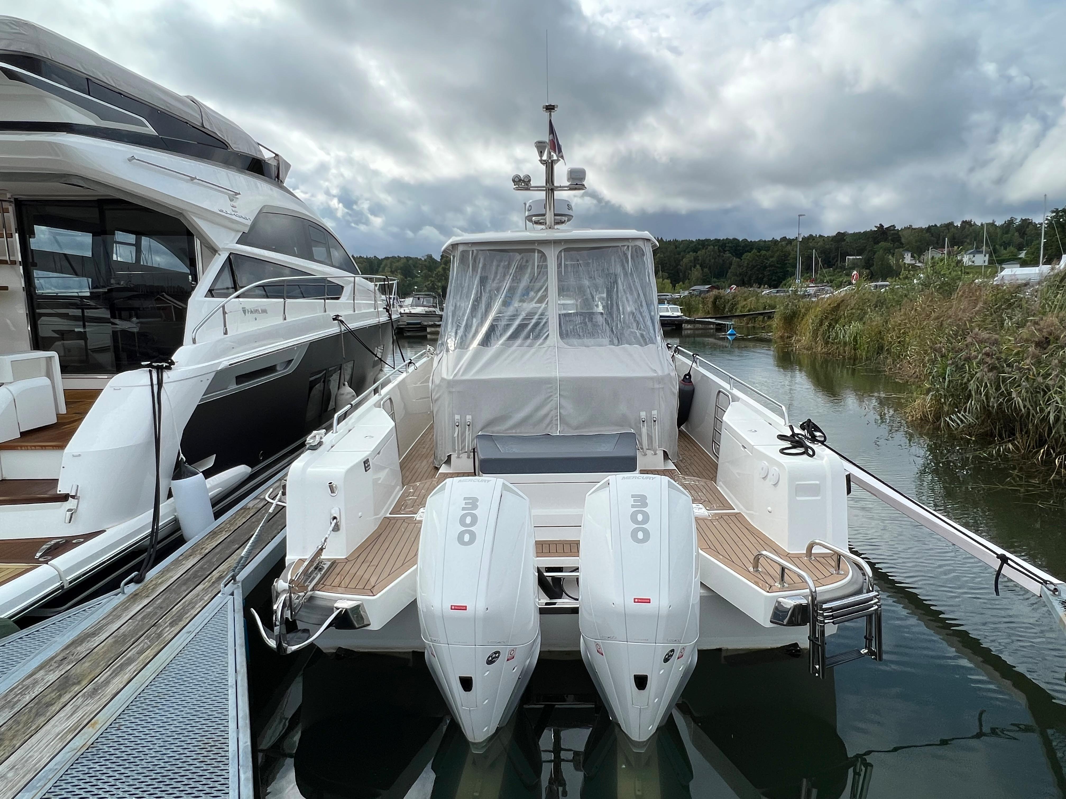 2021 Nimbus Tender 11 boat docked, featuring dual outboard engines and sleek design.