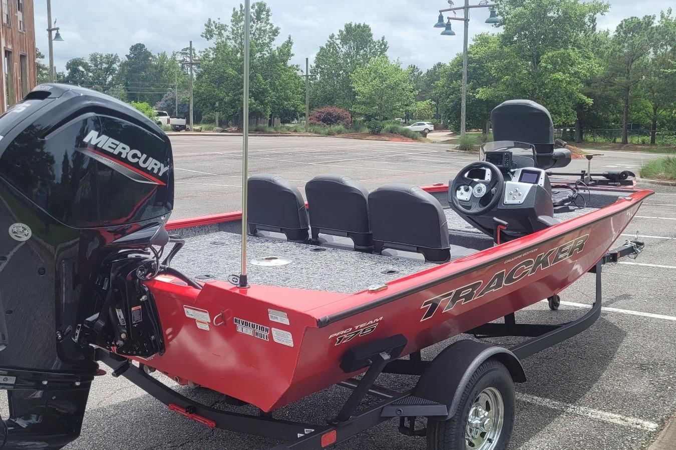 2026 Tracker Pro Team 175 Crappie Edition boat with Mercury engine in parking lot.