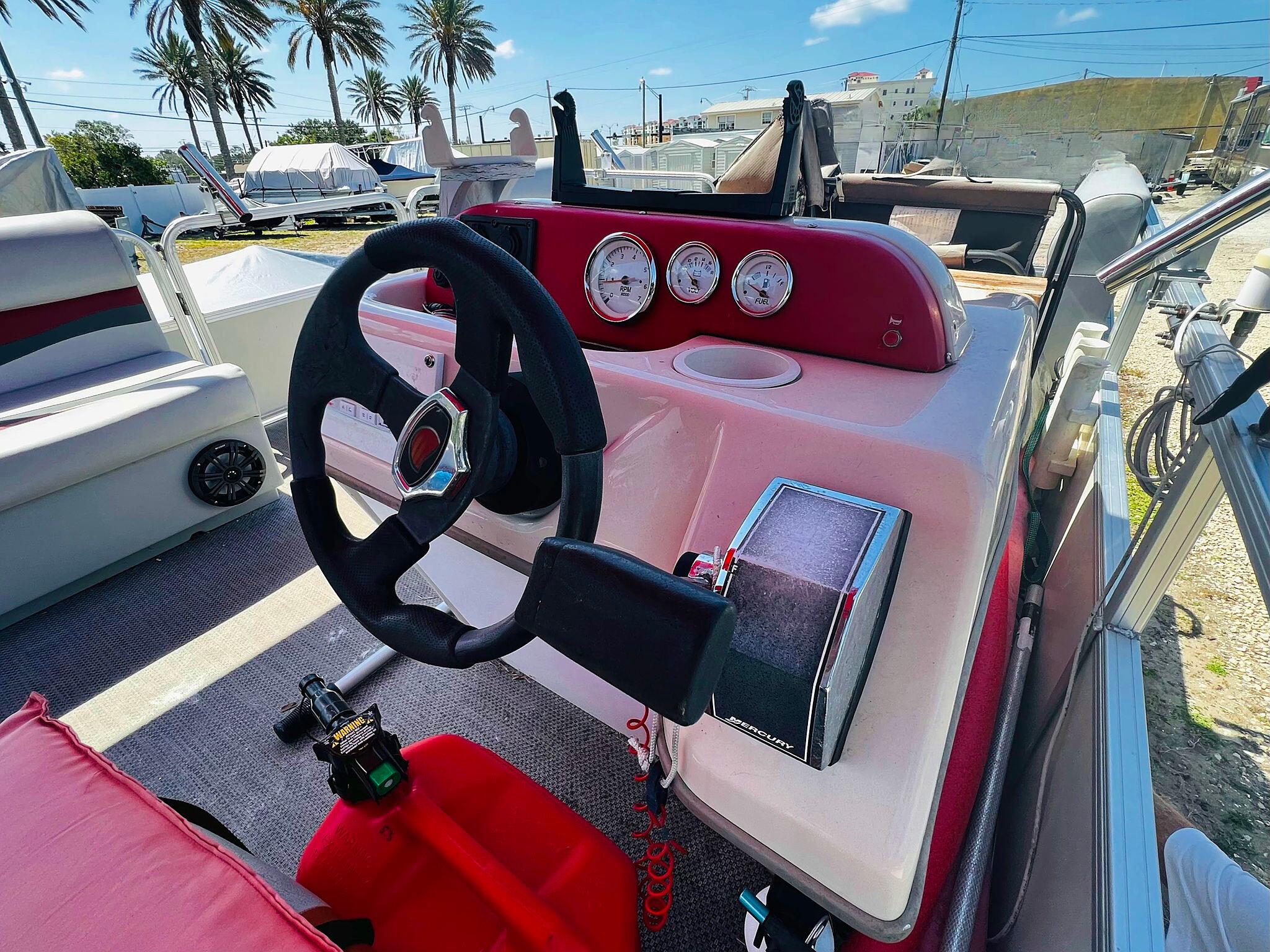 2009 Sun Tracker 200 Party Barge Classic boat dashboard with steering wheel and gauges.