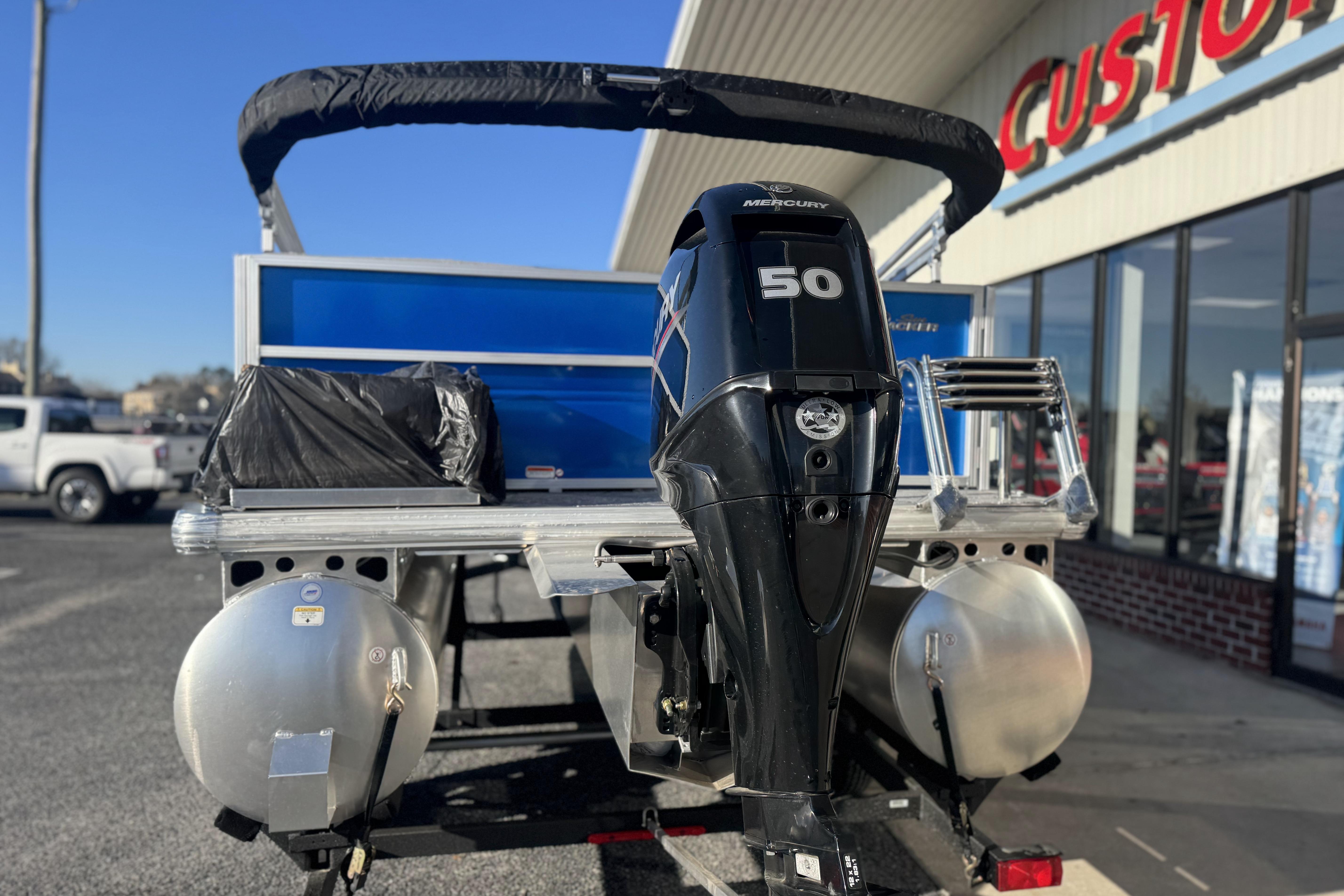 2026 Sun Tracker Party Barge 16 DLX with Mercury 50 engine at dealership.