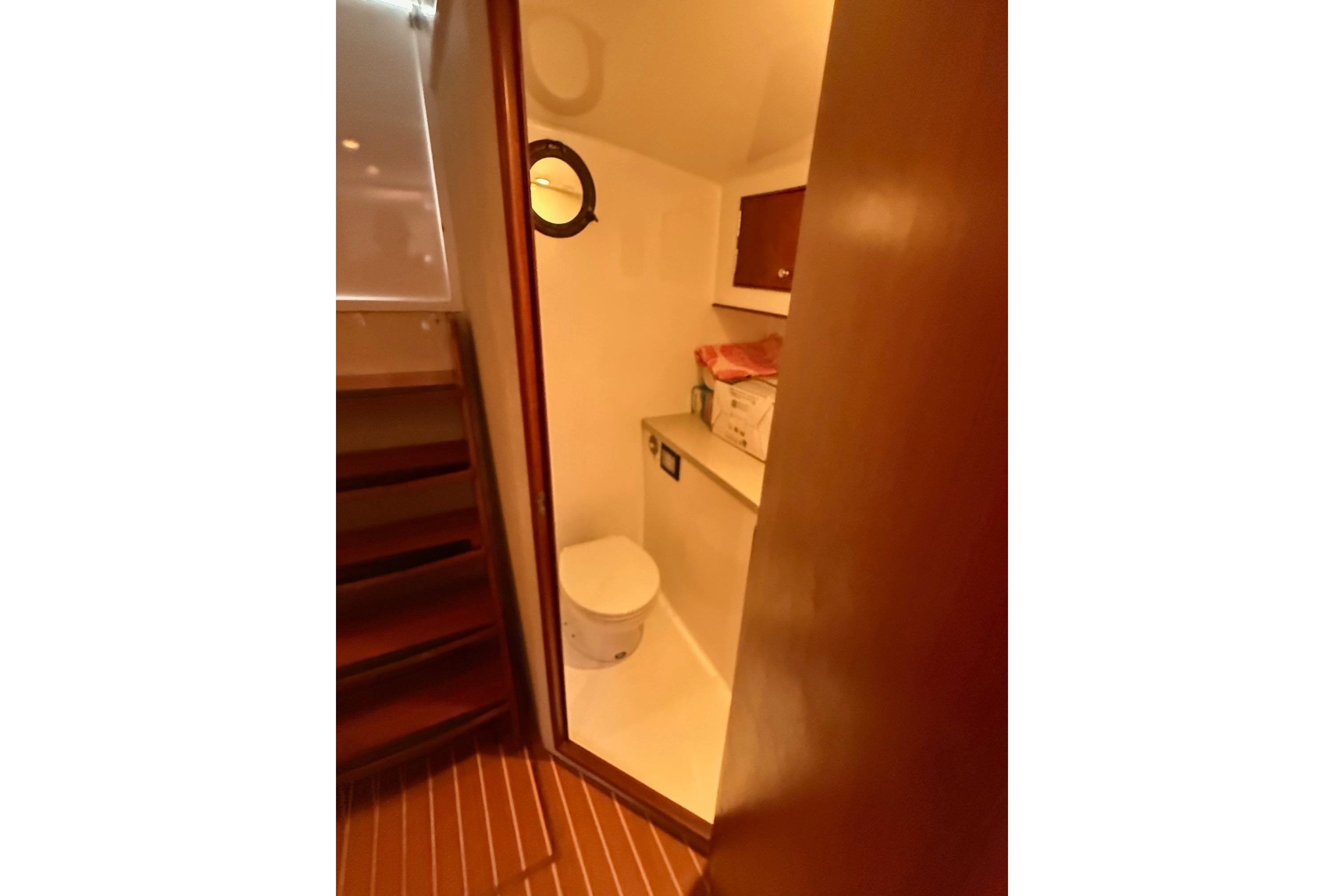 2006 Custom Carolina Heritage Express boat bathroom with wooden accents and compact design.