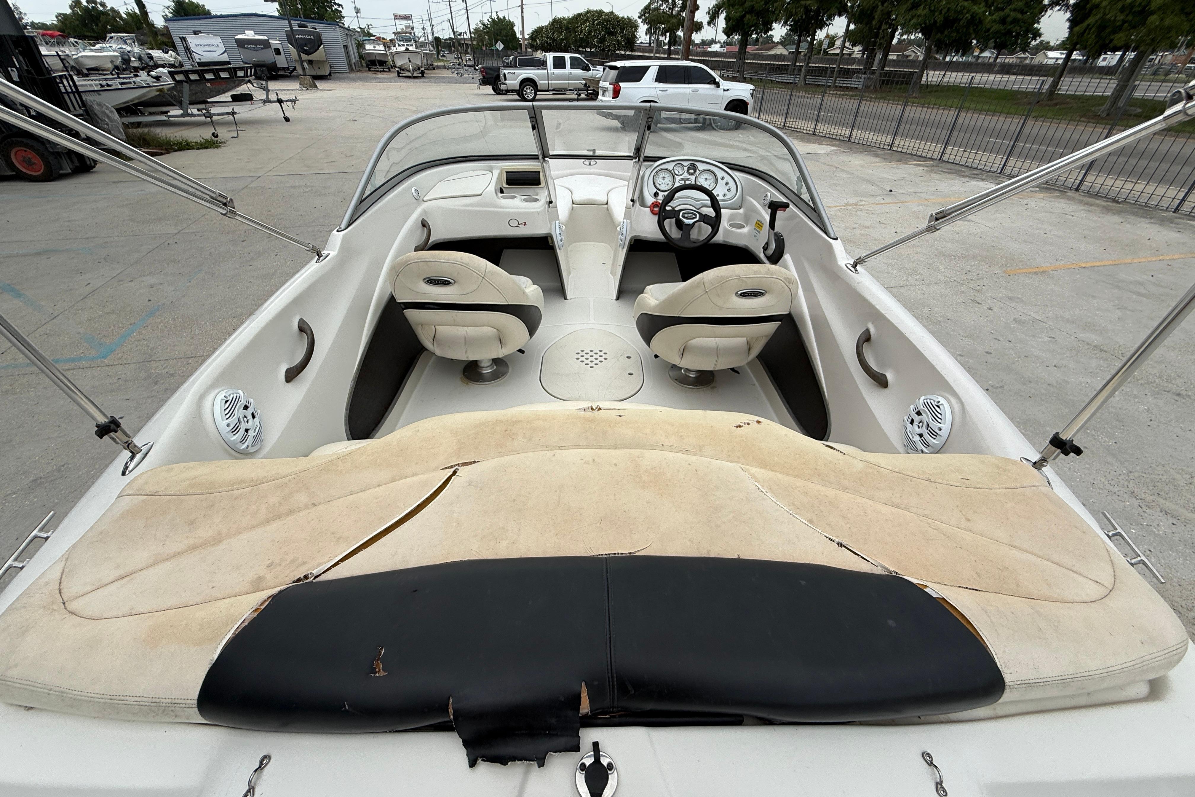 Interior of a 2010 Tahoe Q4 boat with seating and steering wheel.