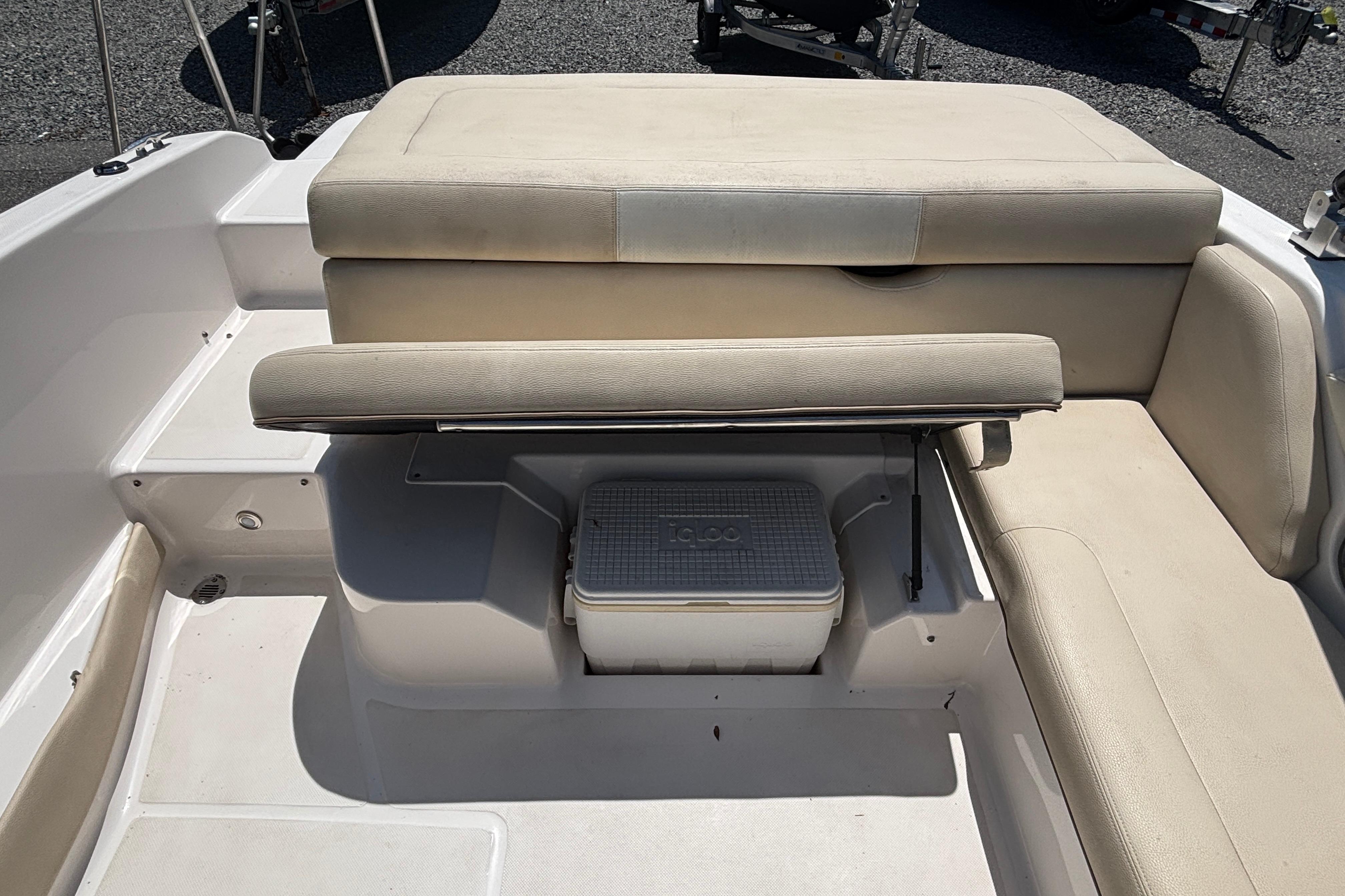 2018 Regal 1900 ES Bowrider interior with beige seating and storage compartment.