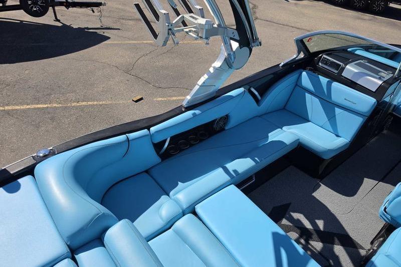 2017 MasterCraft X23 boat interior with blue seating and modern dashboard design.