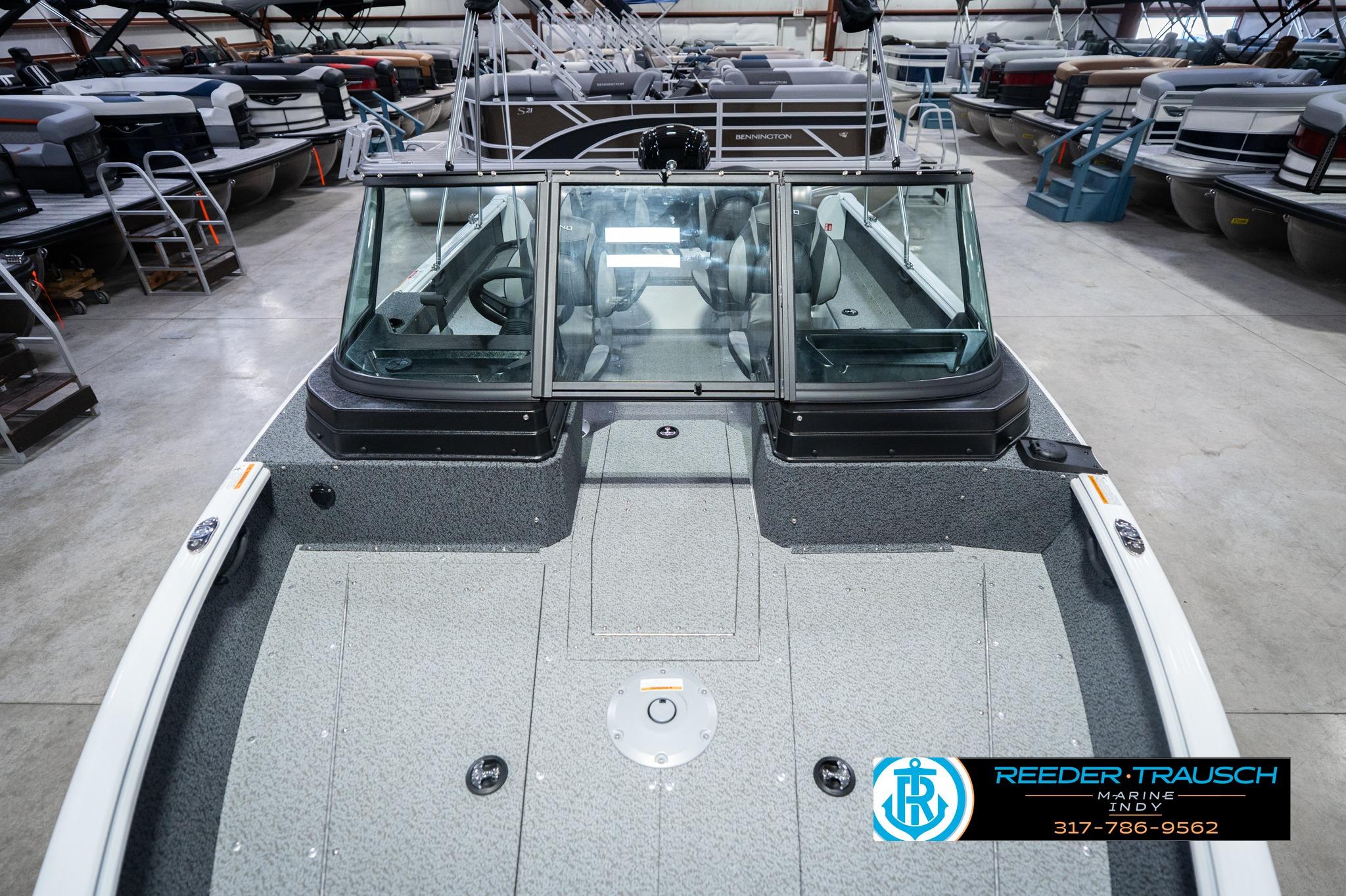 2026 Lund 1700 Explorer Sport boat in showroom, featuring spacious deck and windshield.
