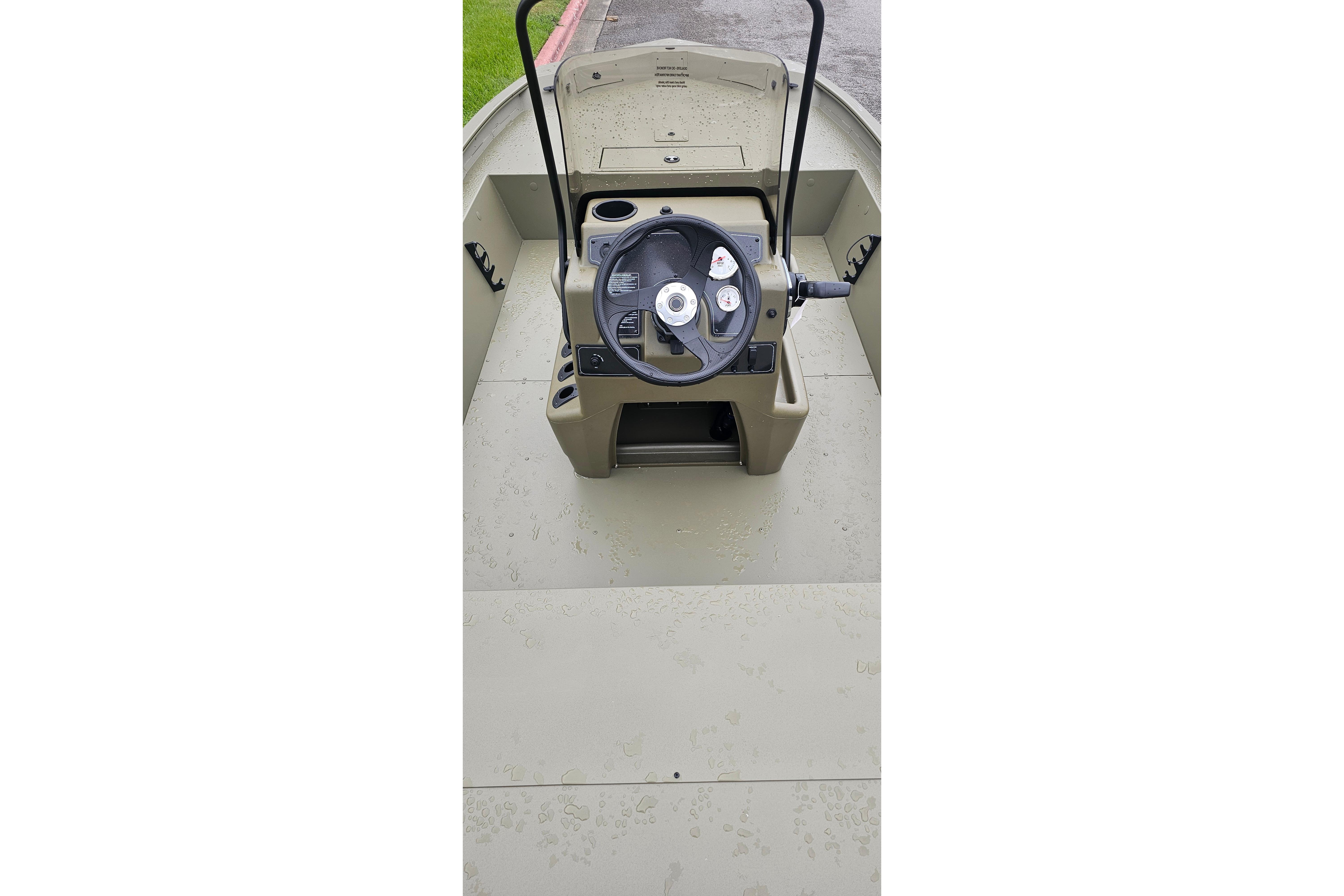 2026 Tracker Grizzly 1860 CC boat console with steering wheel and controls.