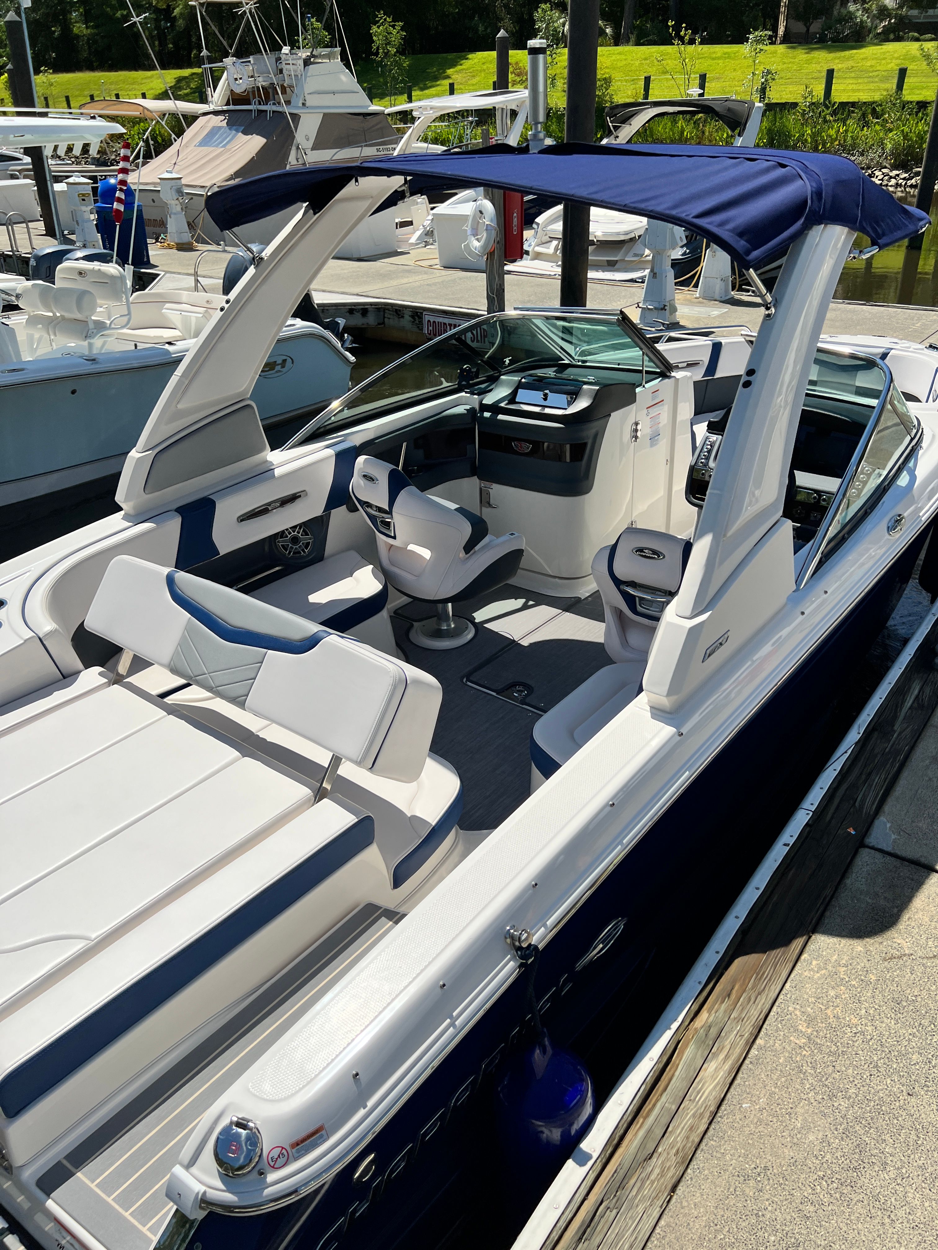 2020 Chaparral 256 SSX boat docked, featuring modern design.