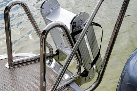 Stainless steel boat ladder on Lowe LS 190, 2026 model, near water.