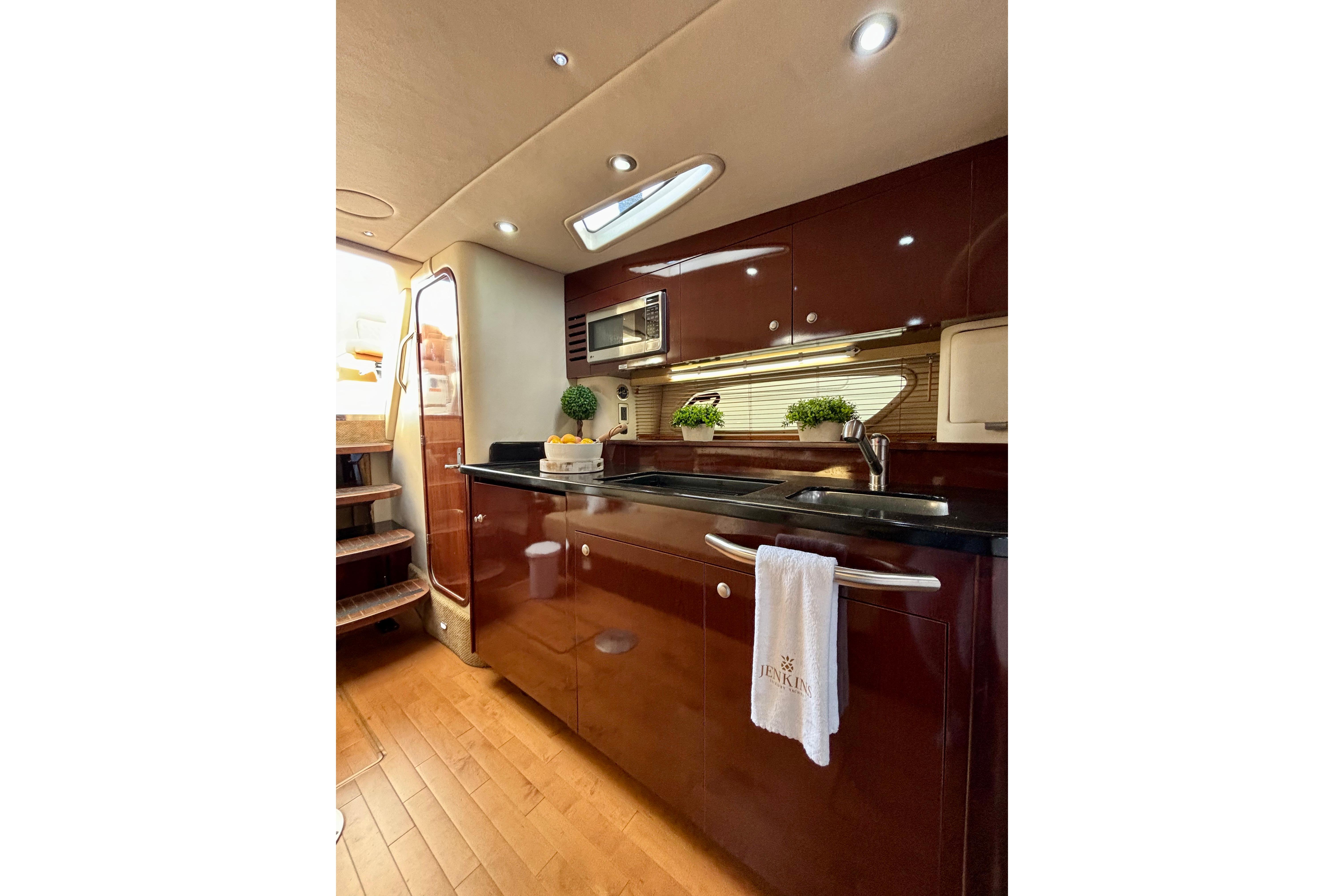 Luxurious 2009 Sea Ray Sundancer 350 yacht interior kitchen with modern amenities and elegant design.