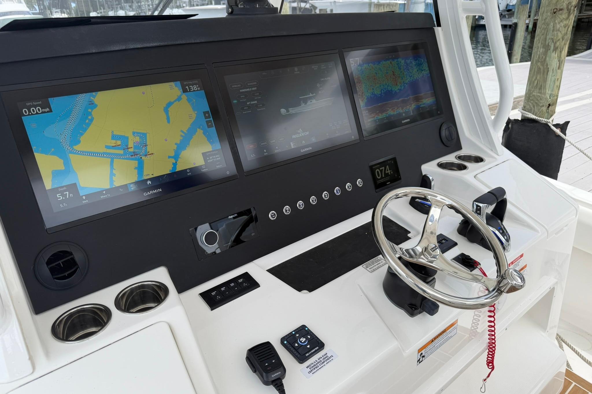 Helm of 2026 Regulator 37 boat with advanced navigation displays and controls.