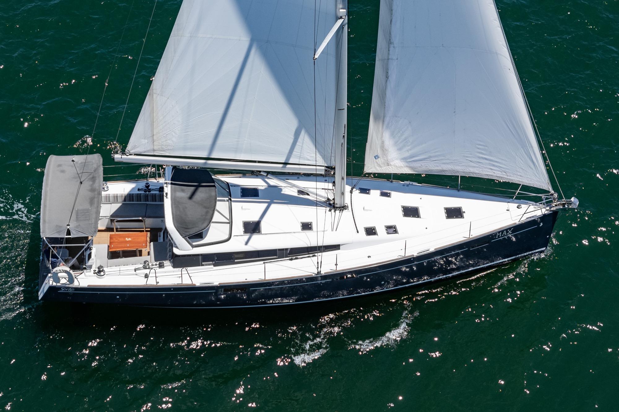 2017 Beneteau Sense 50 sailing yacht on open water, aerial view.