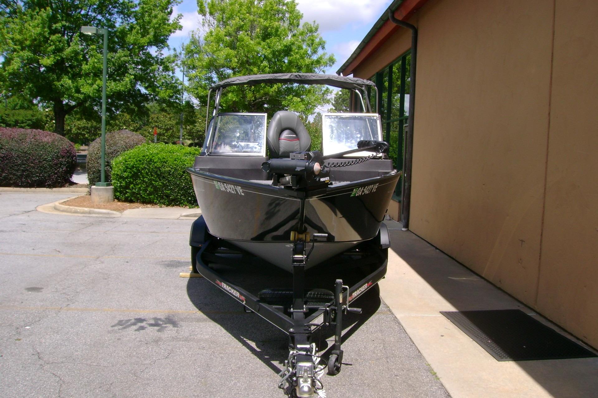 2023 Tracker Pro Guide V-175 WT boat parked outdoors on a sunny day.