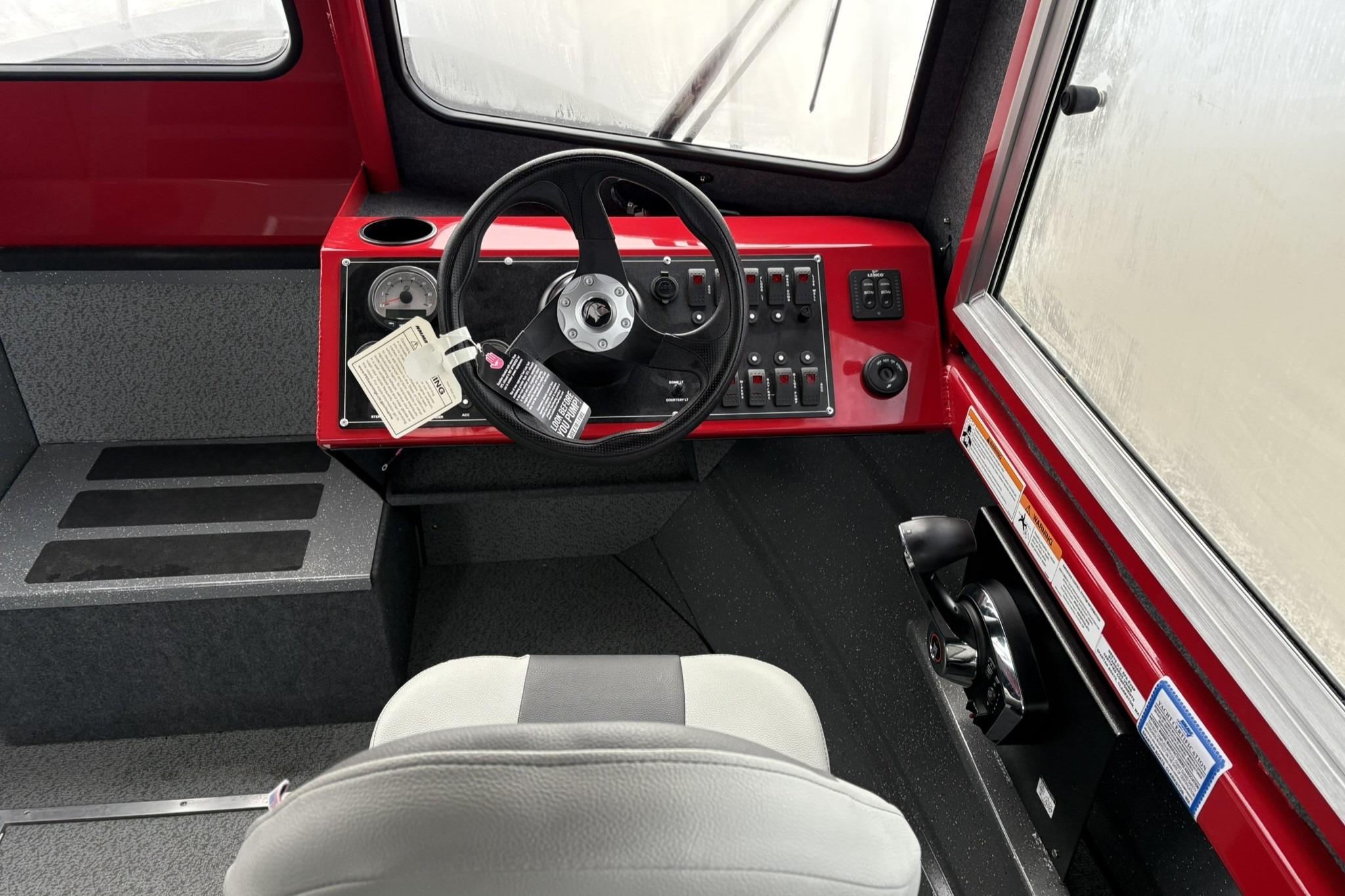 2024 Spartan 240 Maximus Pro boat interior with steering wheel and control panel.