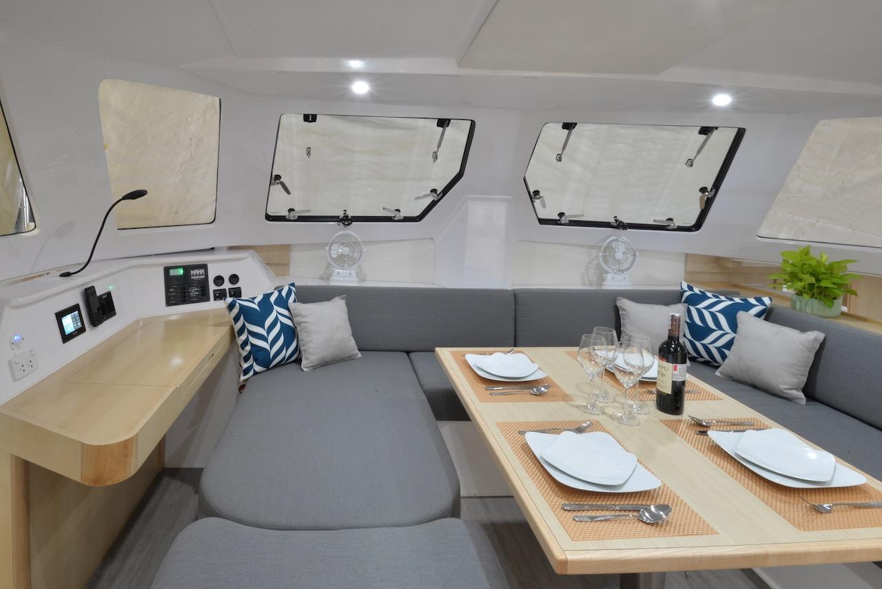 Modern interior of 2025 Seawind 1170 yacht with dining area and stylish decor.