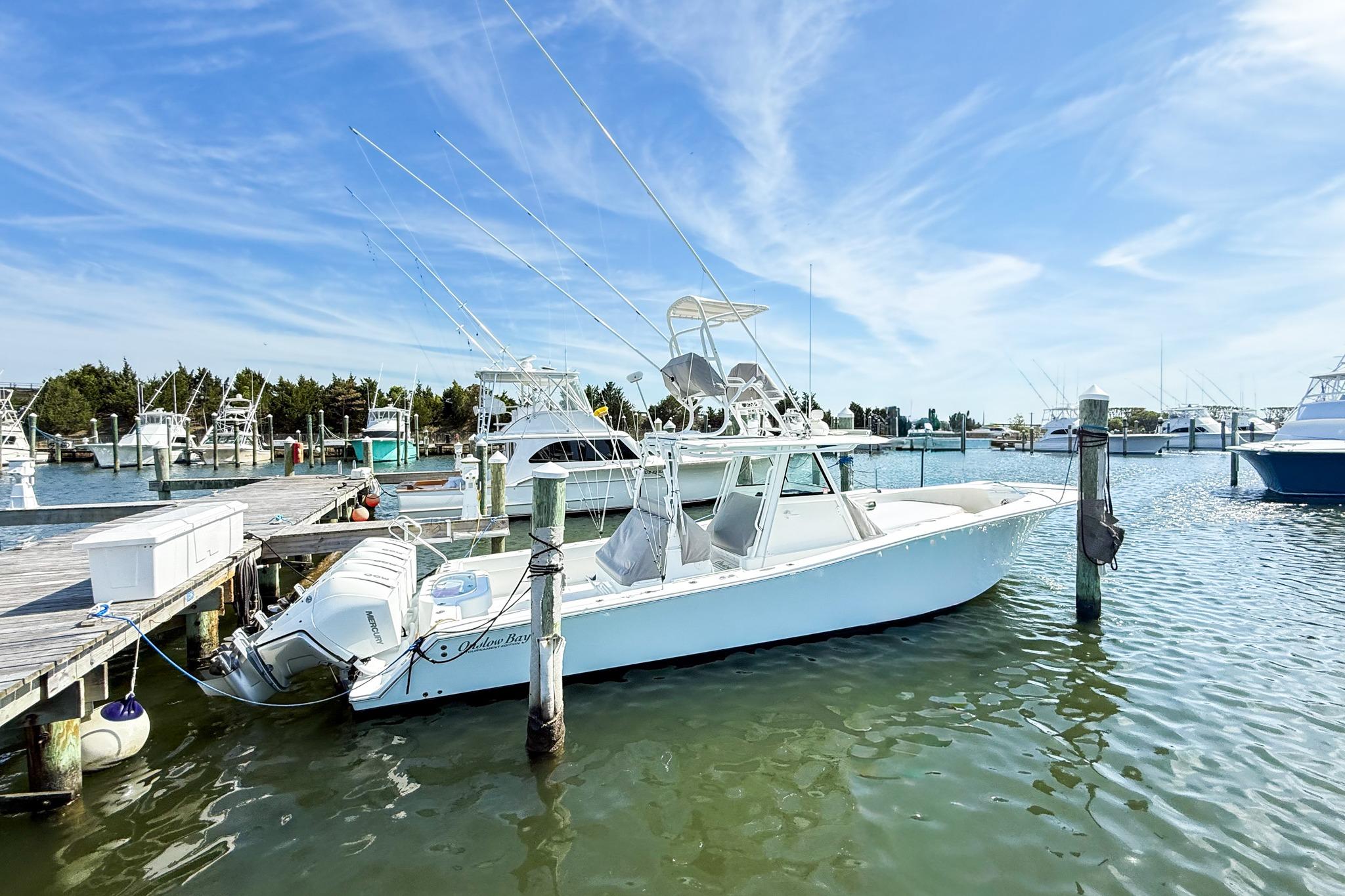 2022 Onslow Bay 41 Tournament boat docked at marina under clear blue sky.