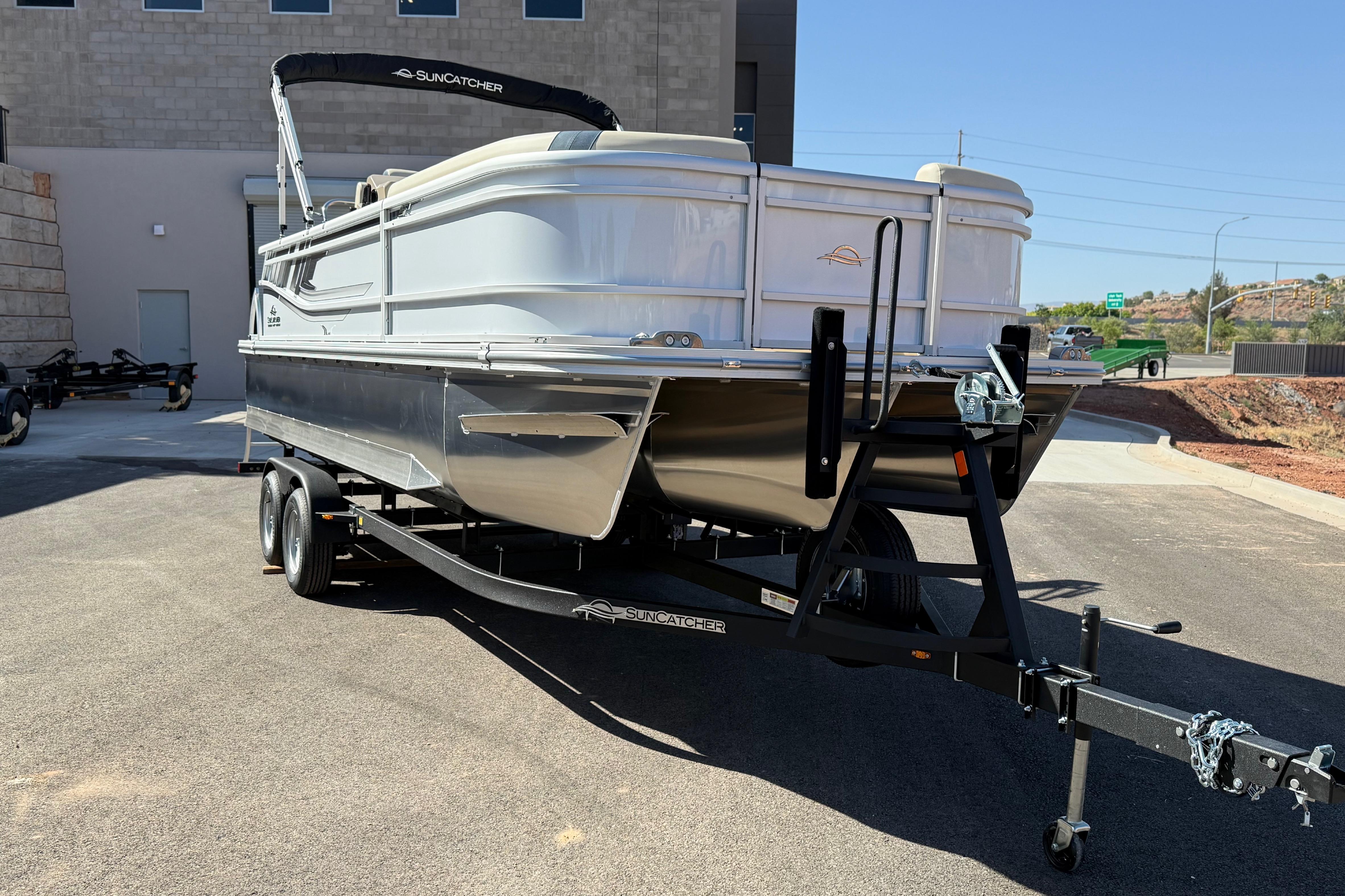 2026 SunCatcher Select 322SL pontoon boat on trailer, parked outdoors.
