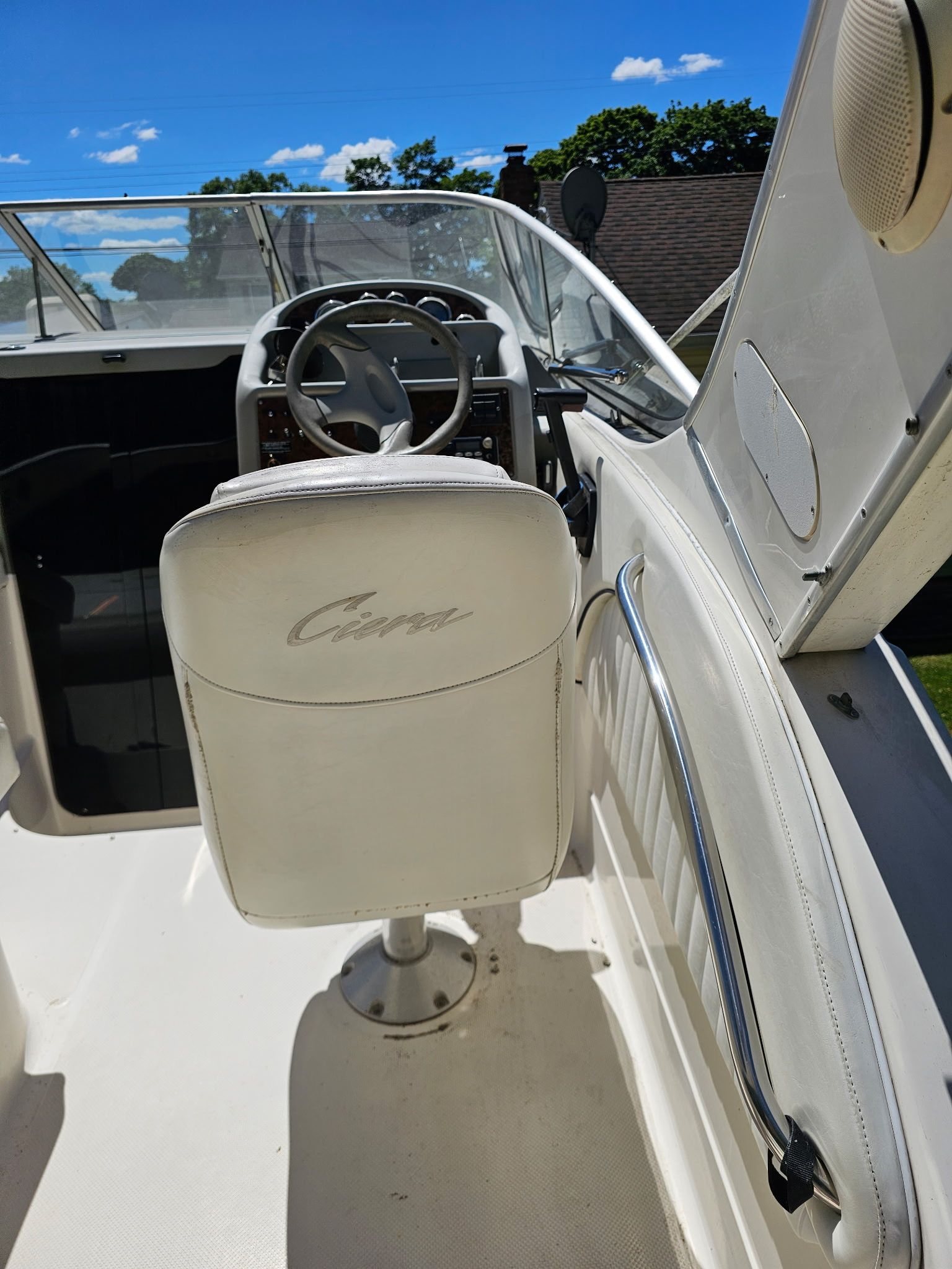 Interior view of a 1998 Bayliner 2855 Ciera Sunbridge with white seating and helm.