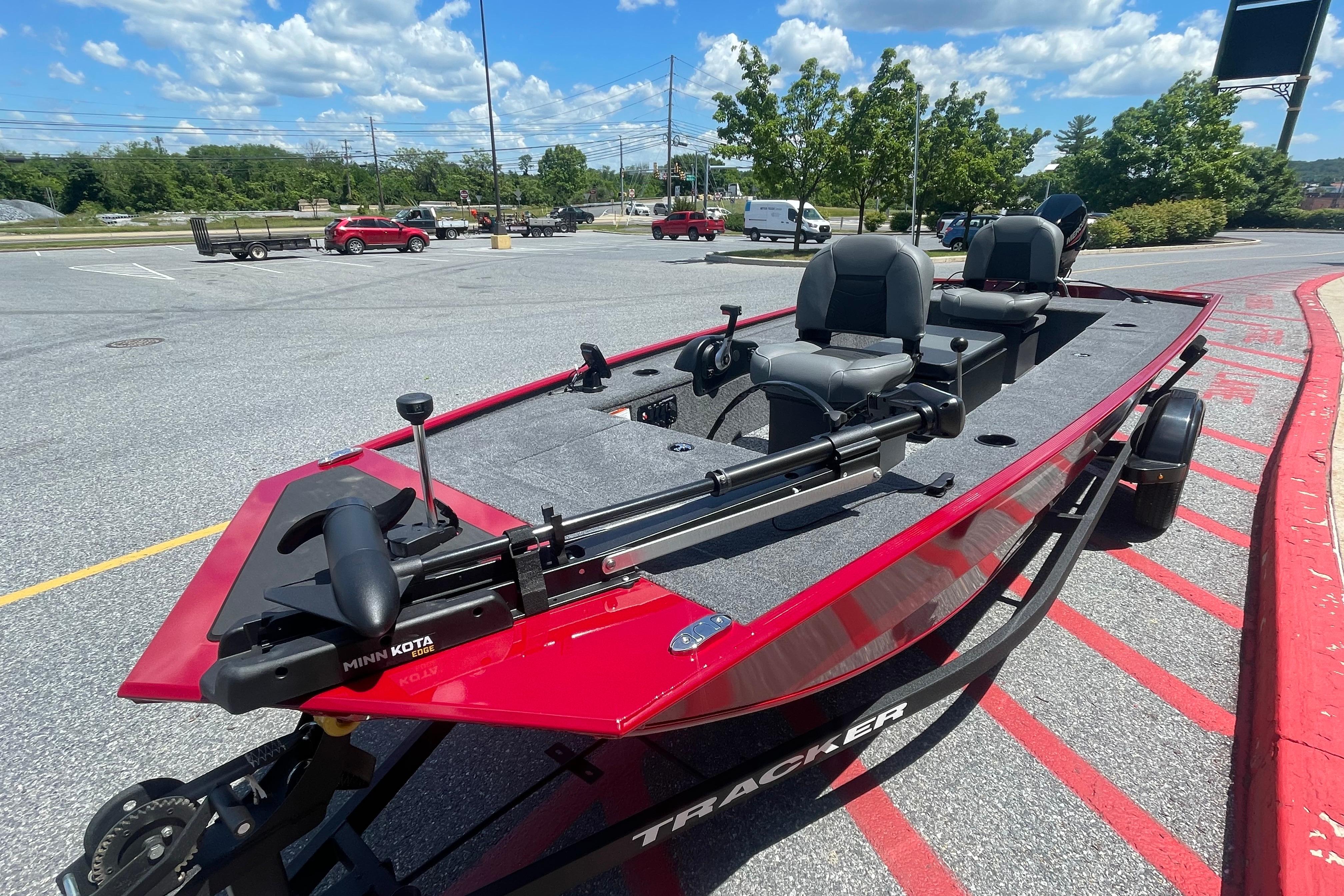 2026 Tracker Panfish 17 boat in parking lot, featuring Minn Kota trolling motor.